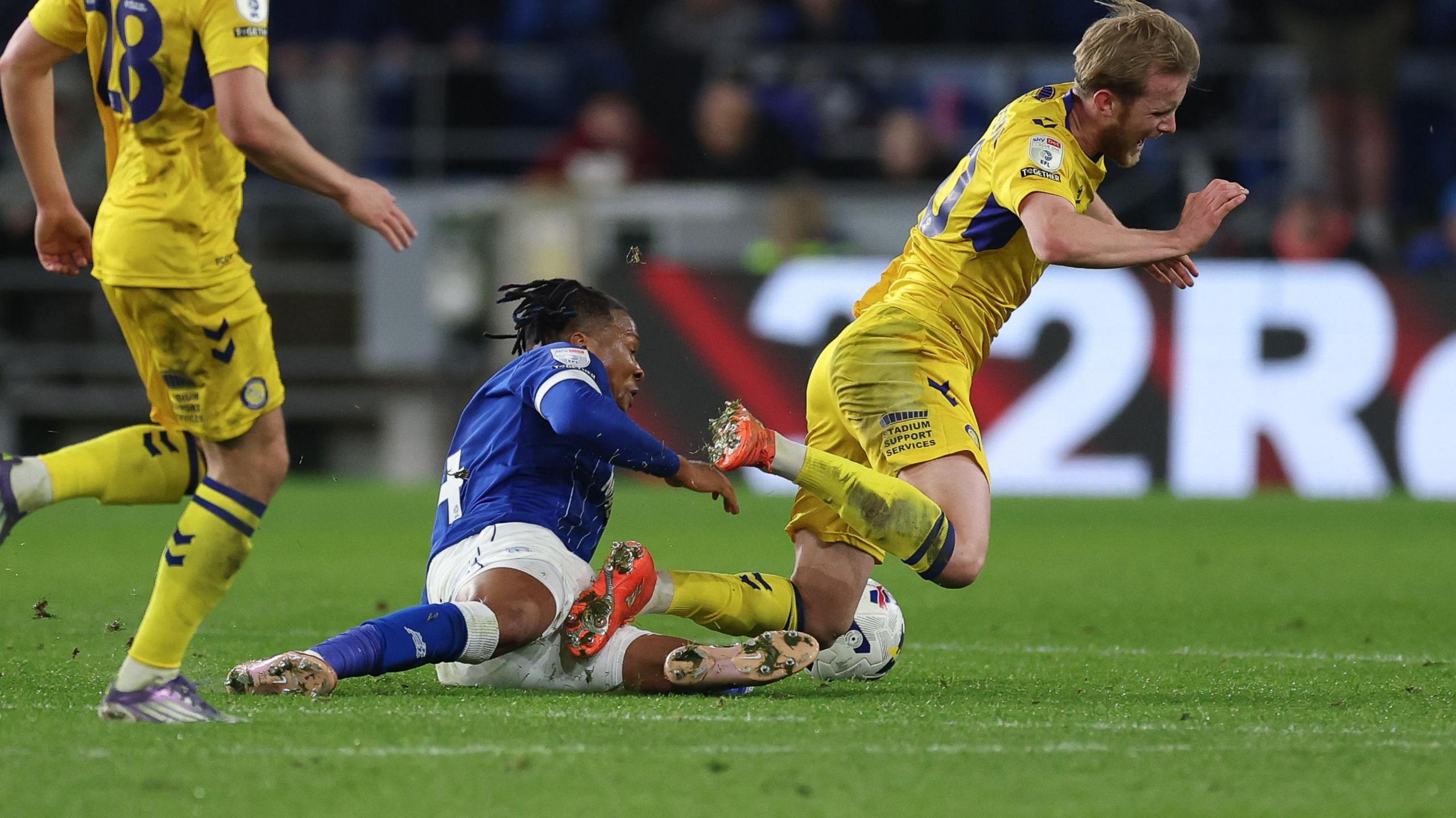 Cardiff's Gabriel Osho slides in on Ewan Henderson to earn a red card