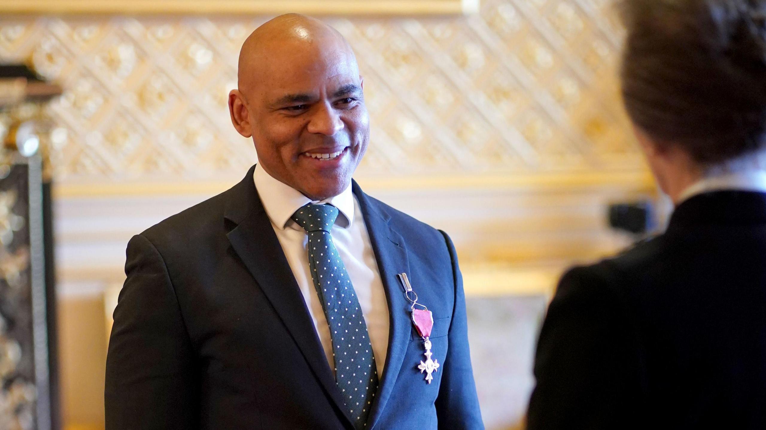 Marvin Rees smiles at Princess Anne as he receives and OBE during a 2024 ceremony