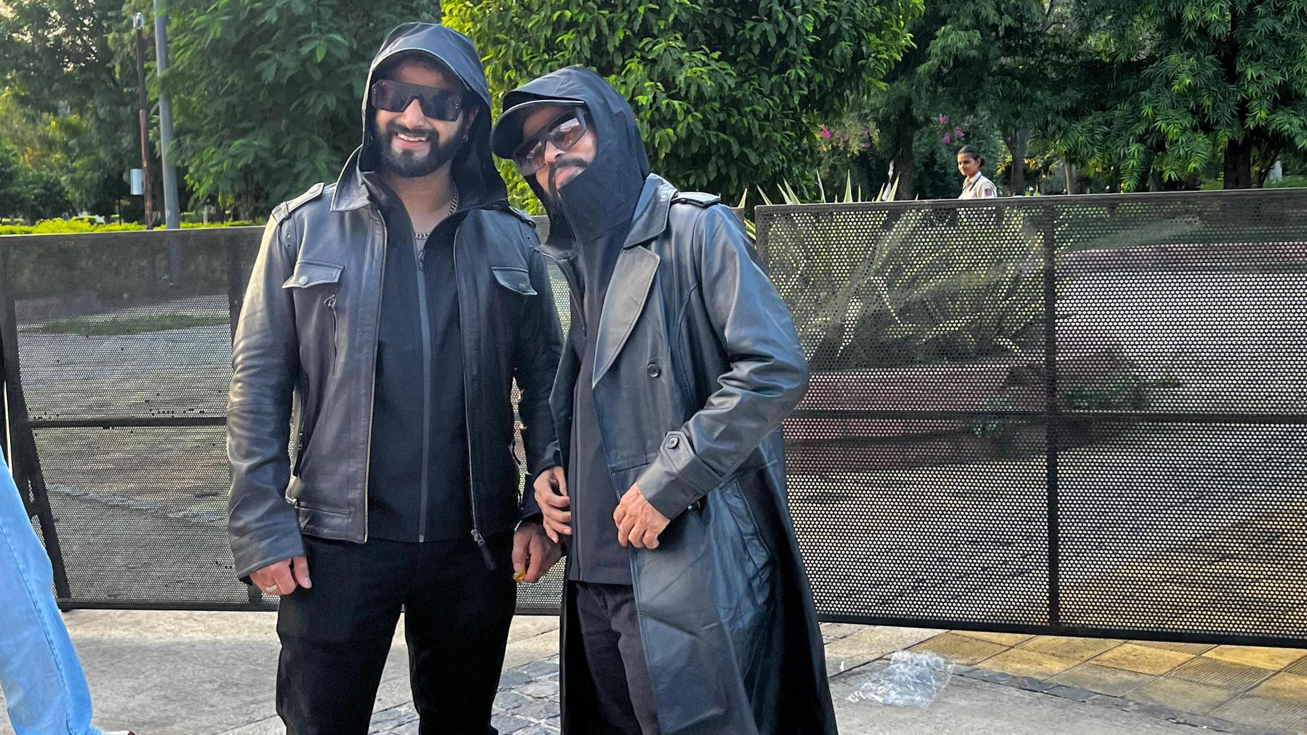 Fans dressed like Reshammiya - in black jackets, shades and caps - pose for a photo at his Delhi concert