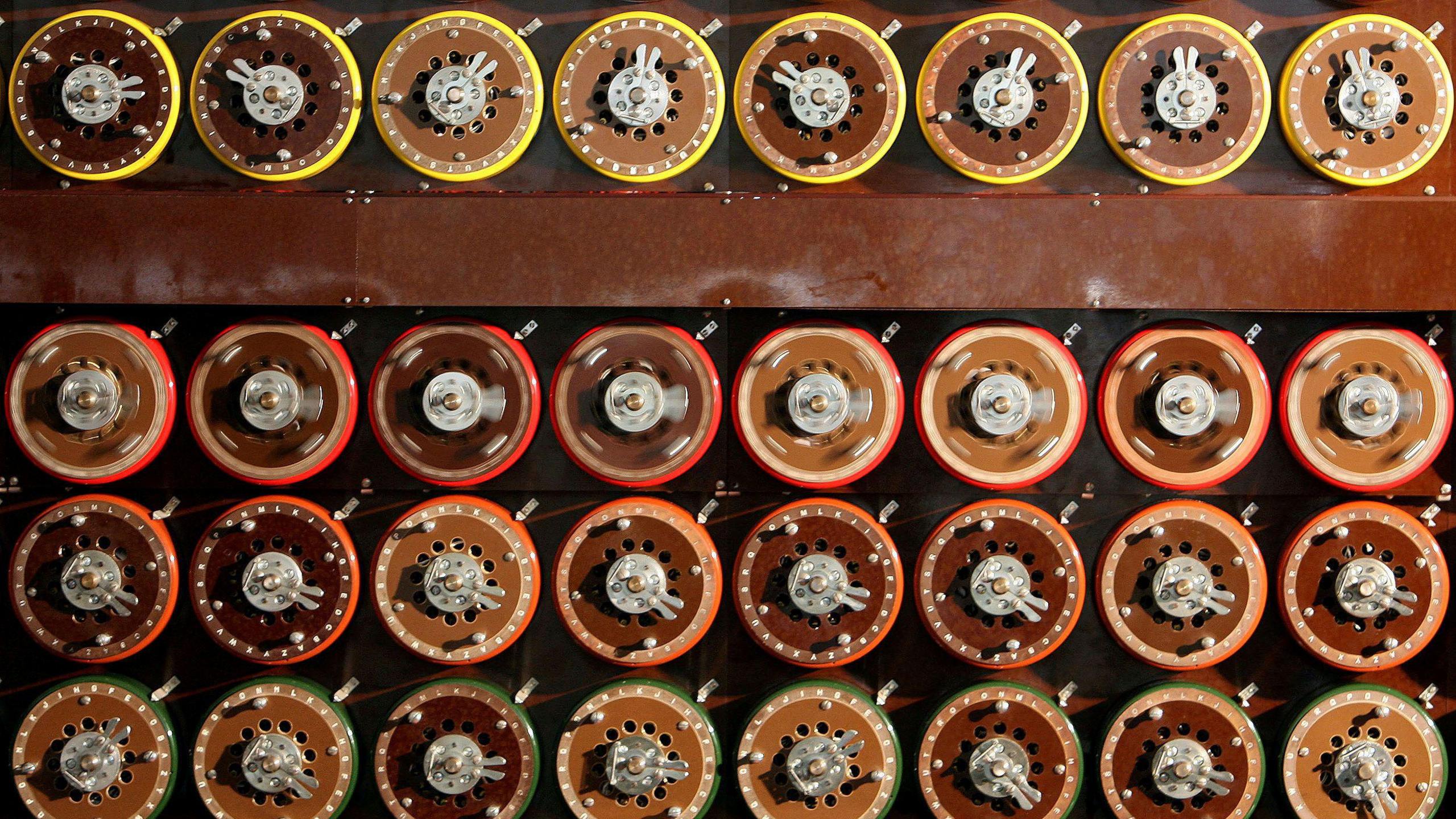 A British Turing Bombe machine is seen functioning in Bletchley Park Museum in Bletchley, central England, September 6, 2006. The machine consists of a regular grid of exposed wheels or cogs, most with letters around the circumference.