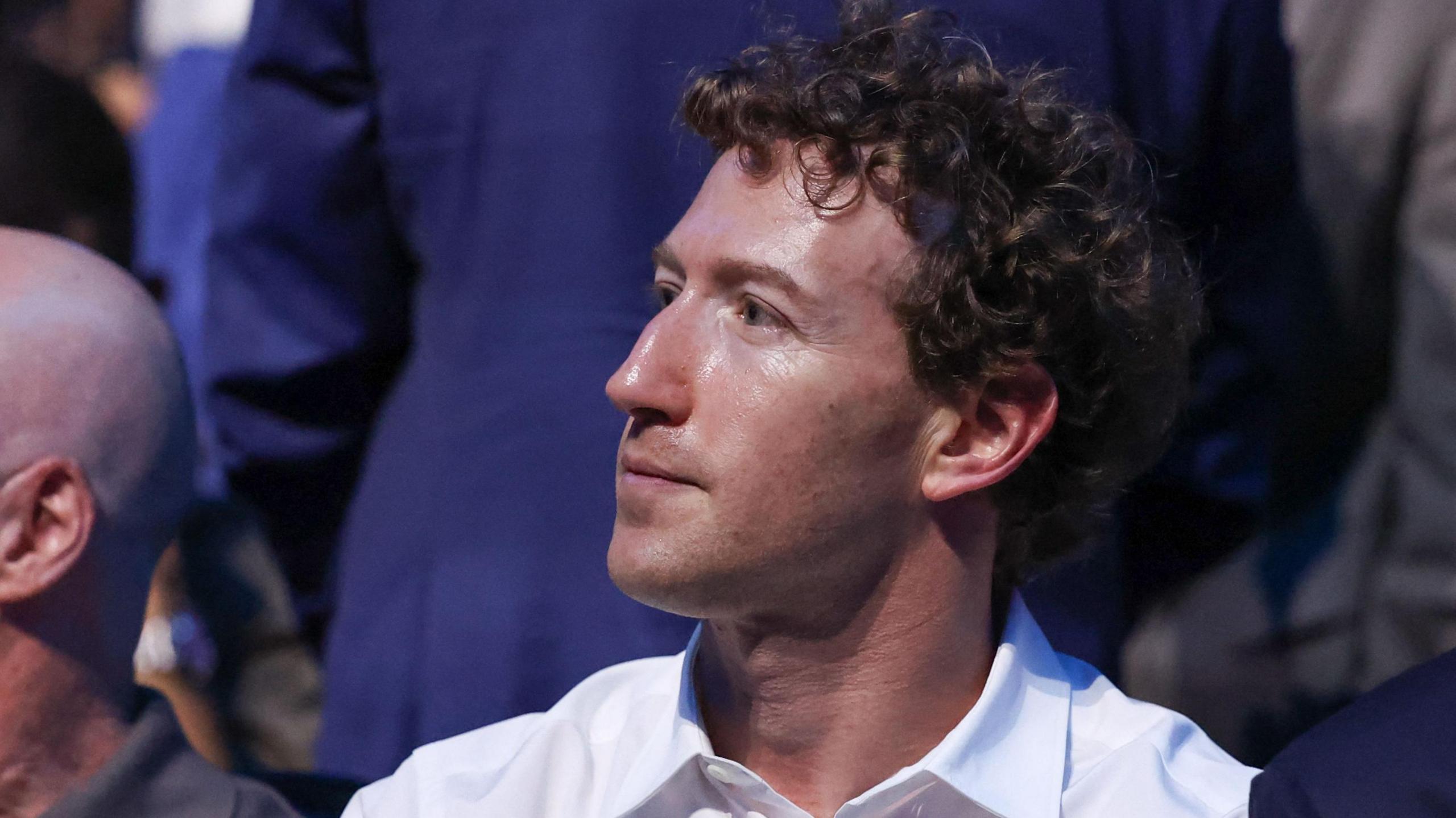 Mark Zuckerberg, wearing a white collared shirt while sitting in a crowd at the recent UFC event at the White House. 