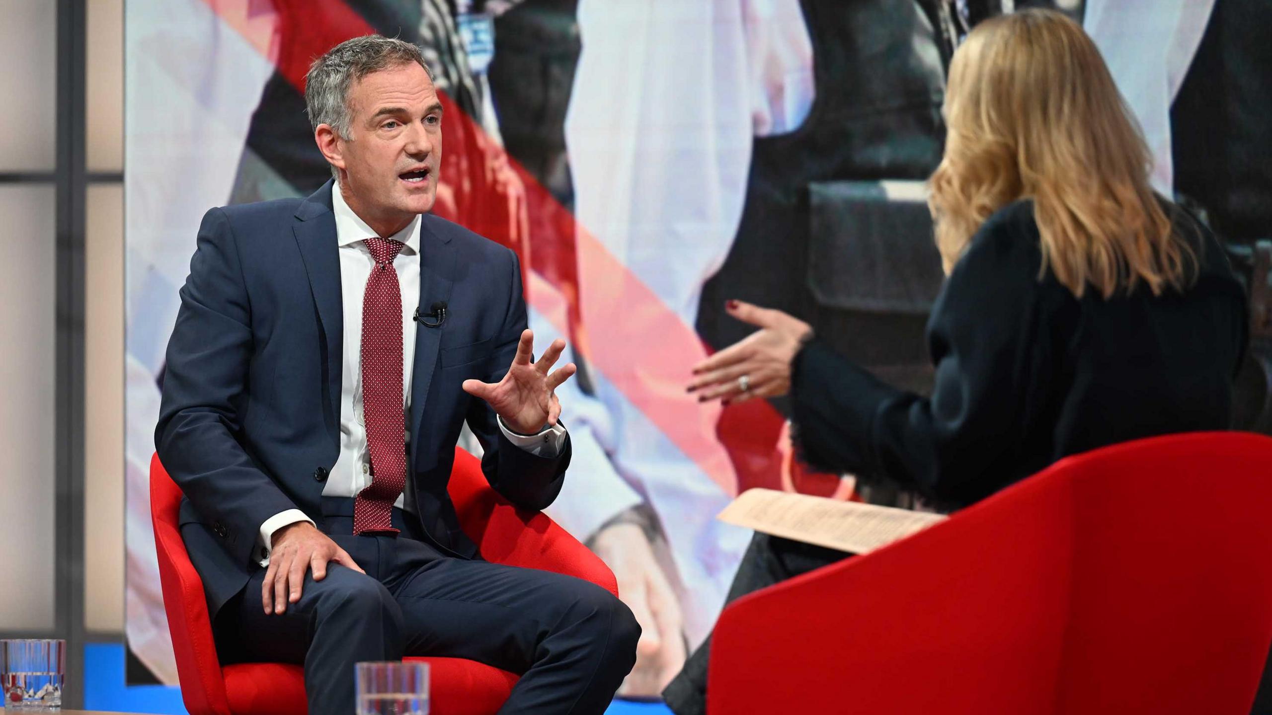 Dressed in a blue suit, white shirt and red tie, Peter Kyle answers a question from BBC presenter Laura Kuenssberg, who is sat opposite on the set of her Sunday morning programme.