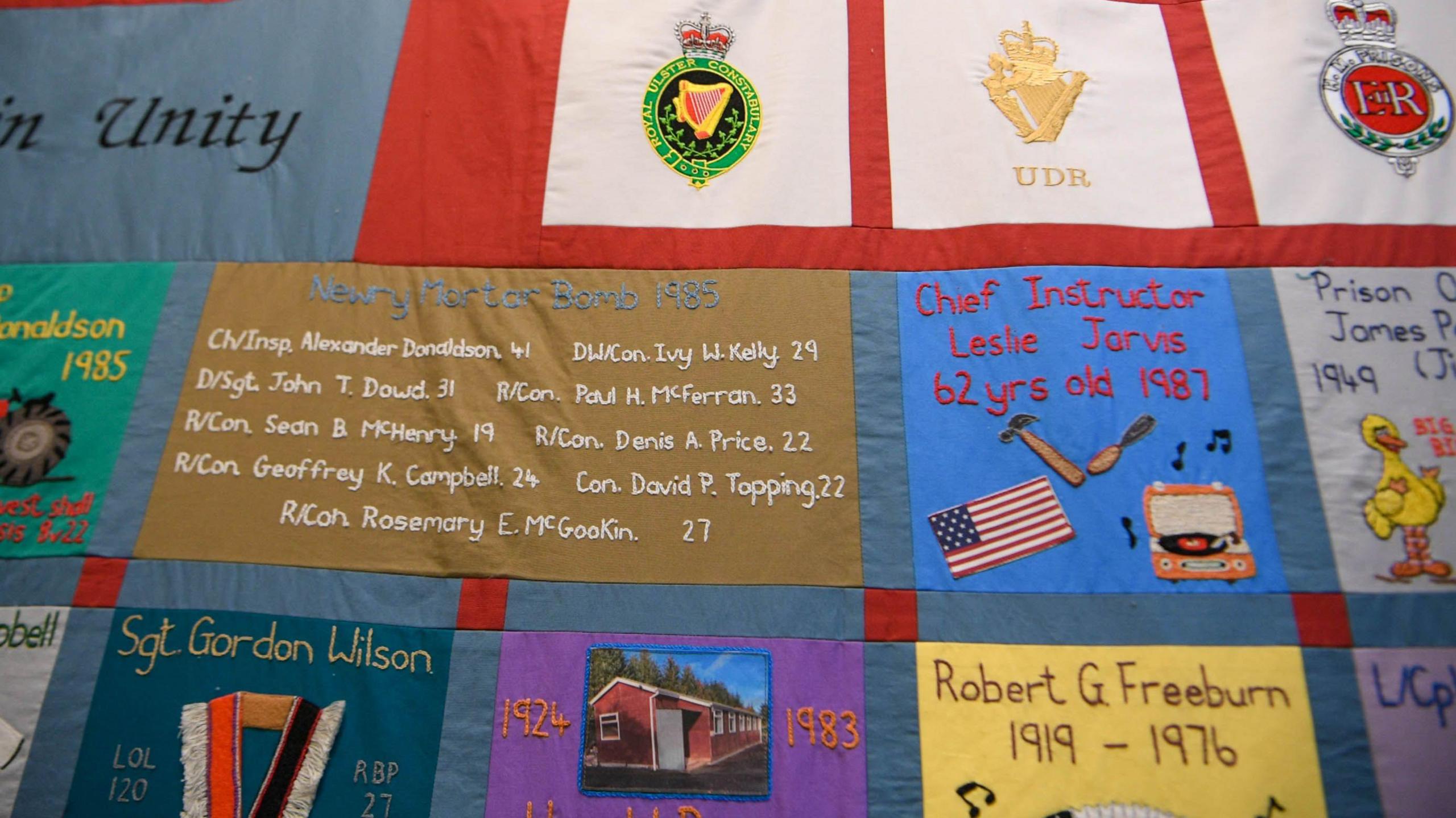 A patchwork quilt showing the names, ages and RUC positions held by those who were killed. 