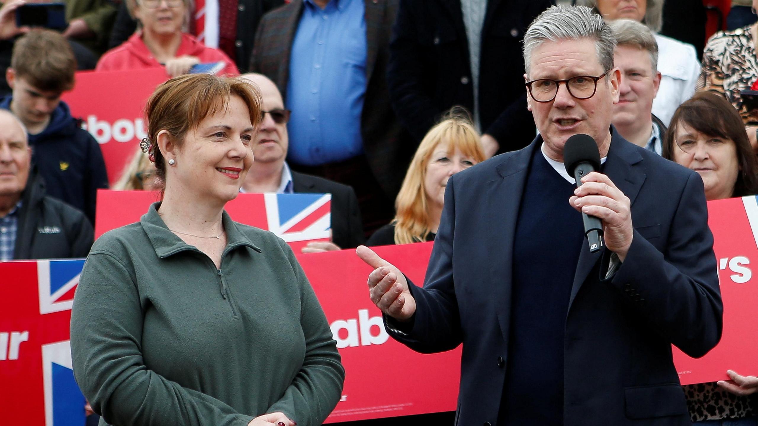 Claire Ward stood next to Keir Starmer on a campaign visit infront of labour party signs