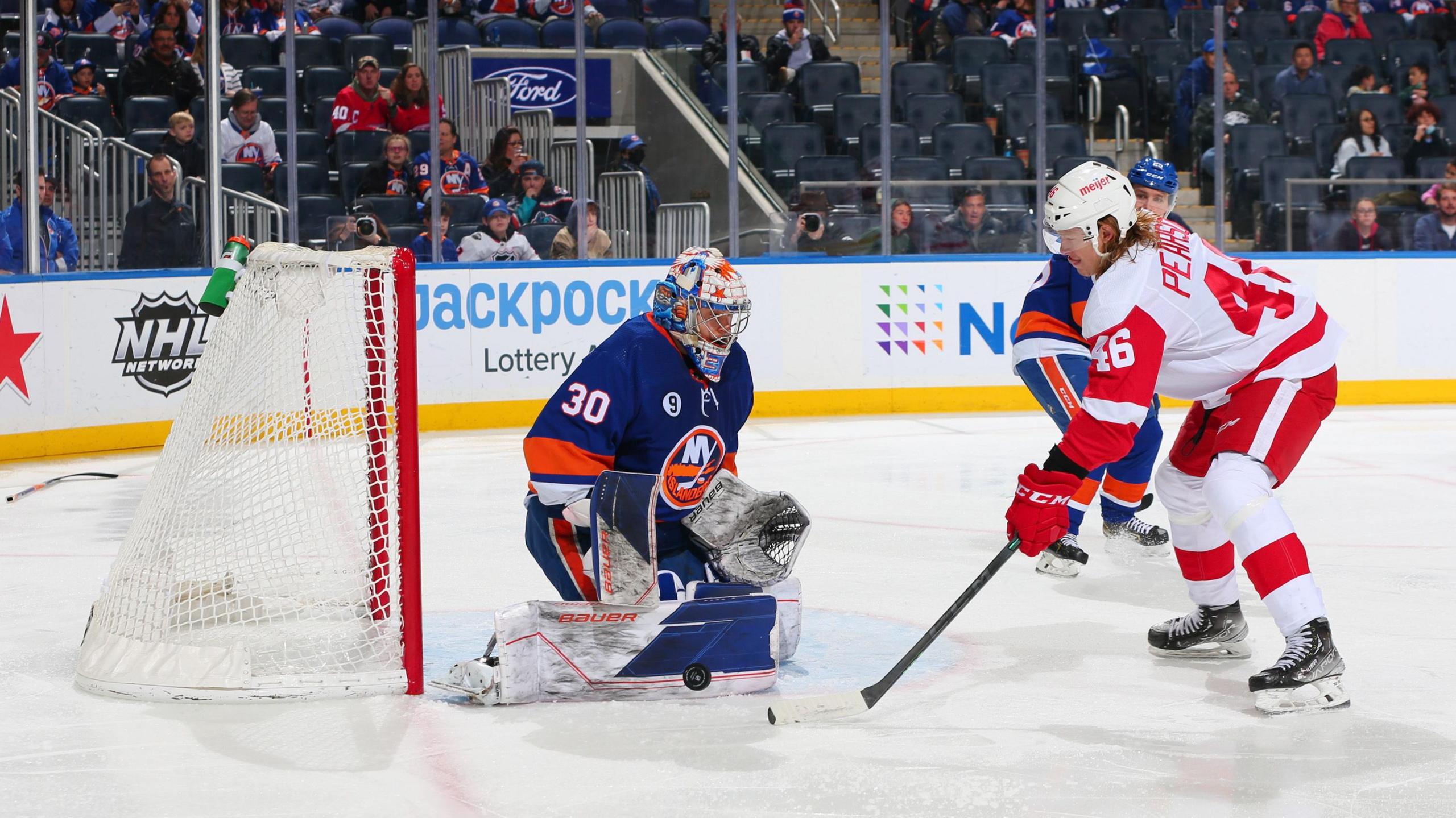 Ilya Sorokin #30 of the New York Islanders makes a save against Chase Pearson #46 of the Detroit Red Wings at UBS Arena on March 24, 2022 in Elmont, New York