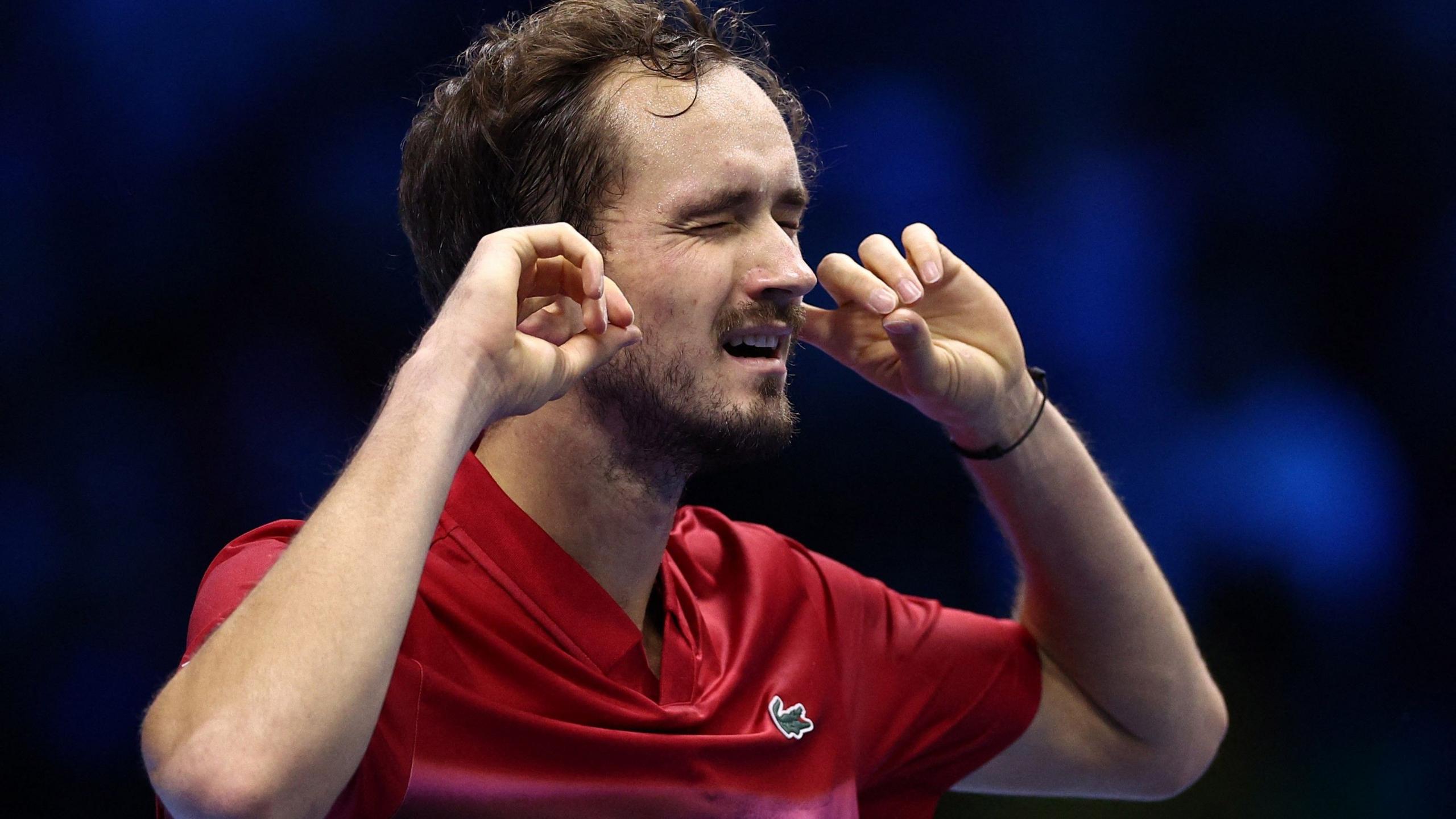 Daniil Medvedev puts his fingers in his ears and closes his eyes