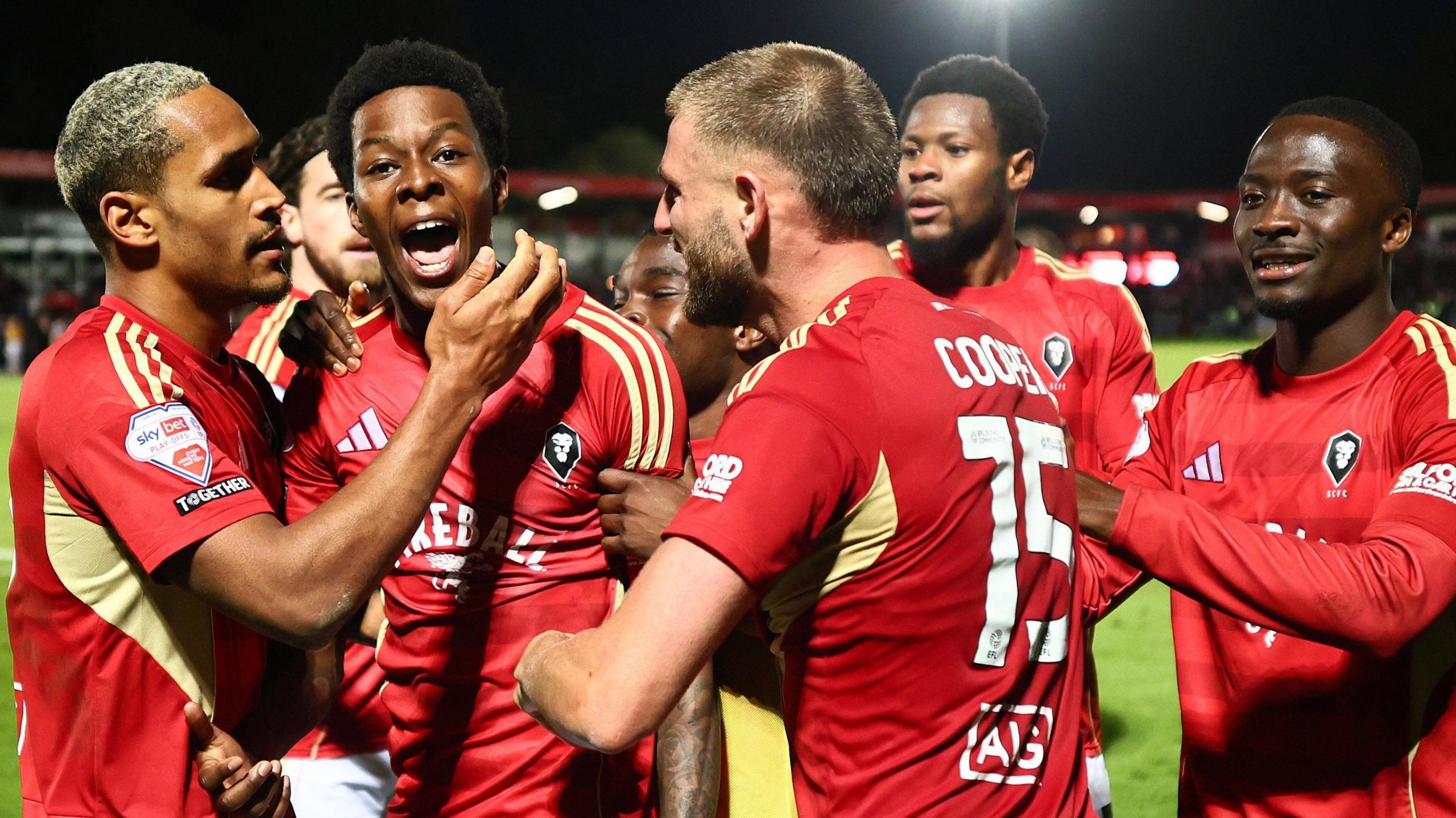Salford City celebrate Kallum Cesay's goal against Grimsby Town