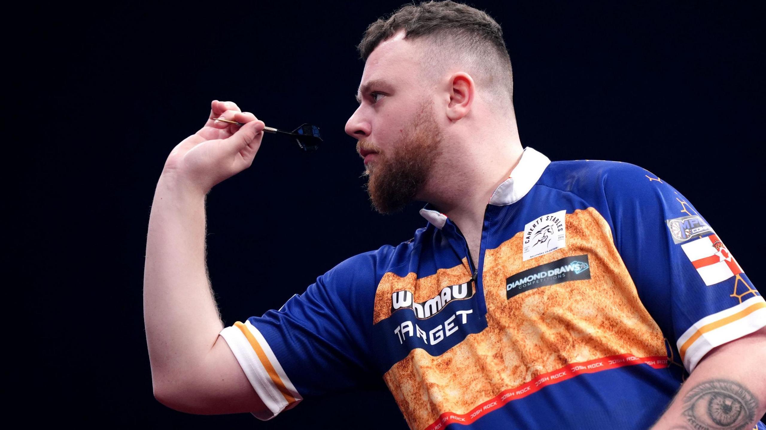 Josh Rock throws a dart