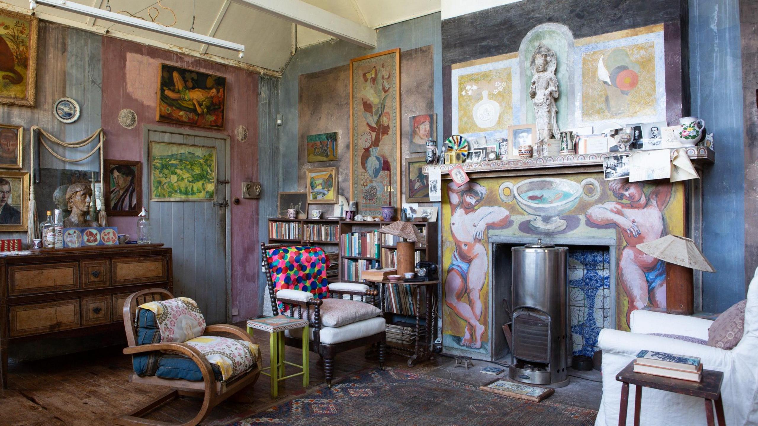 An interior image of Charleston House, containing many artefacts, art work and furniture by members of the Bloomsbury Group.