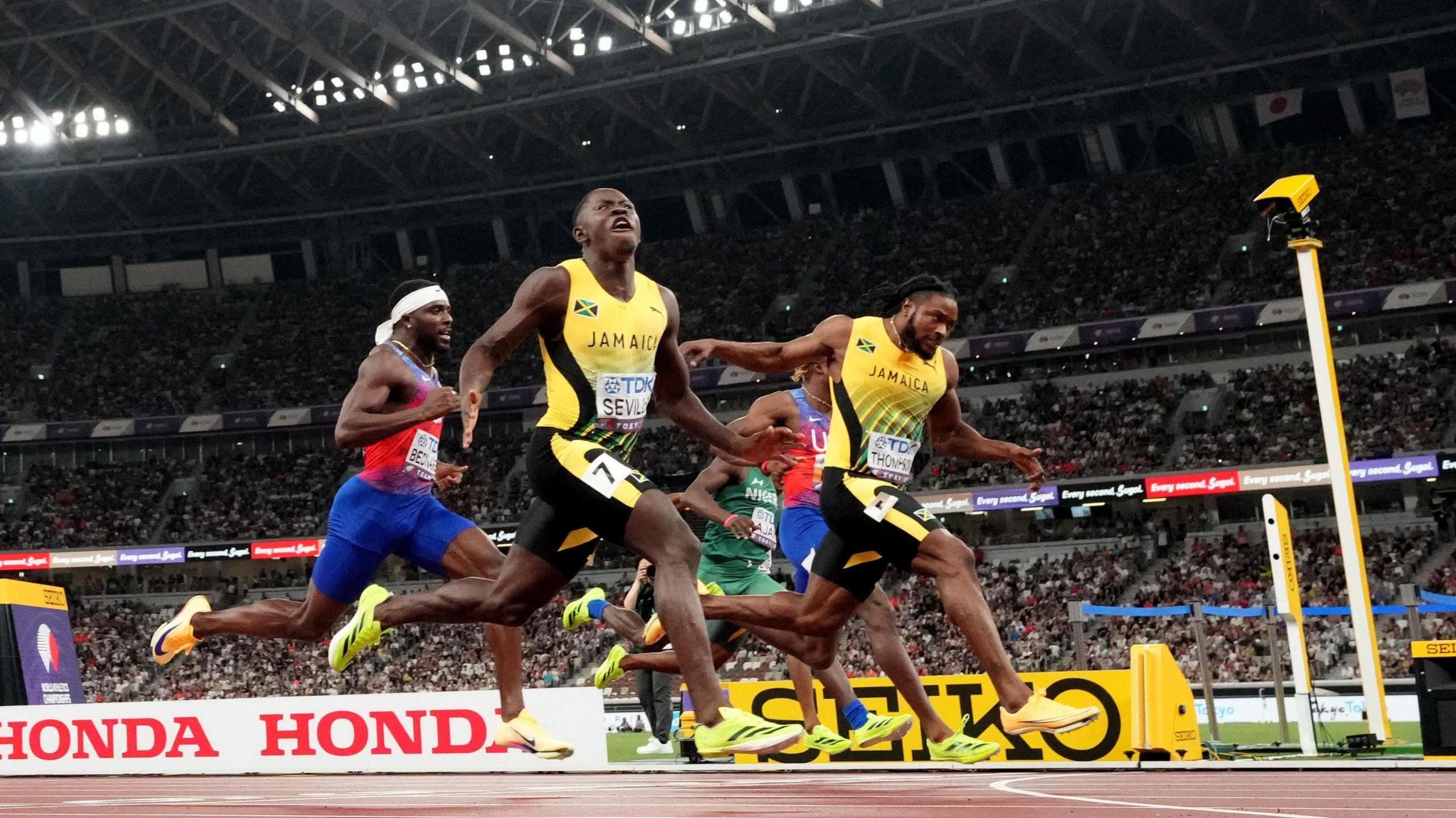 A finish-line photo of the men's 100m final as Oblique Seville crosses the line in front of Kishane Thompson
