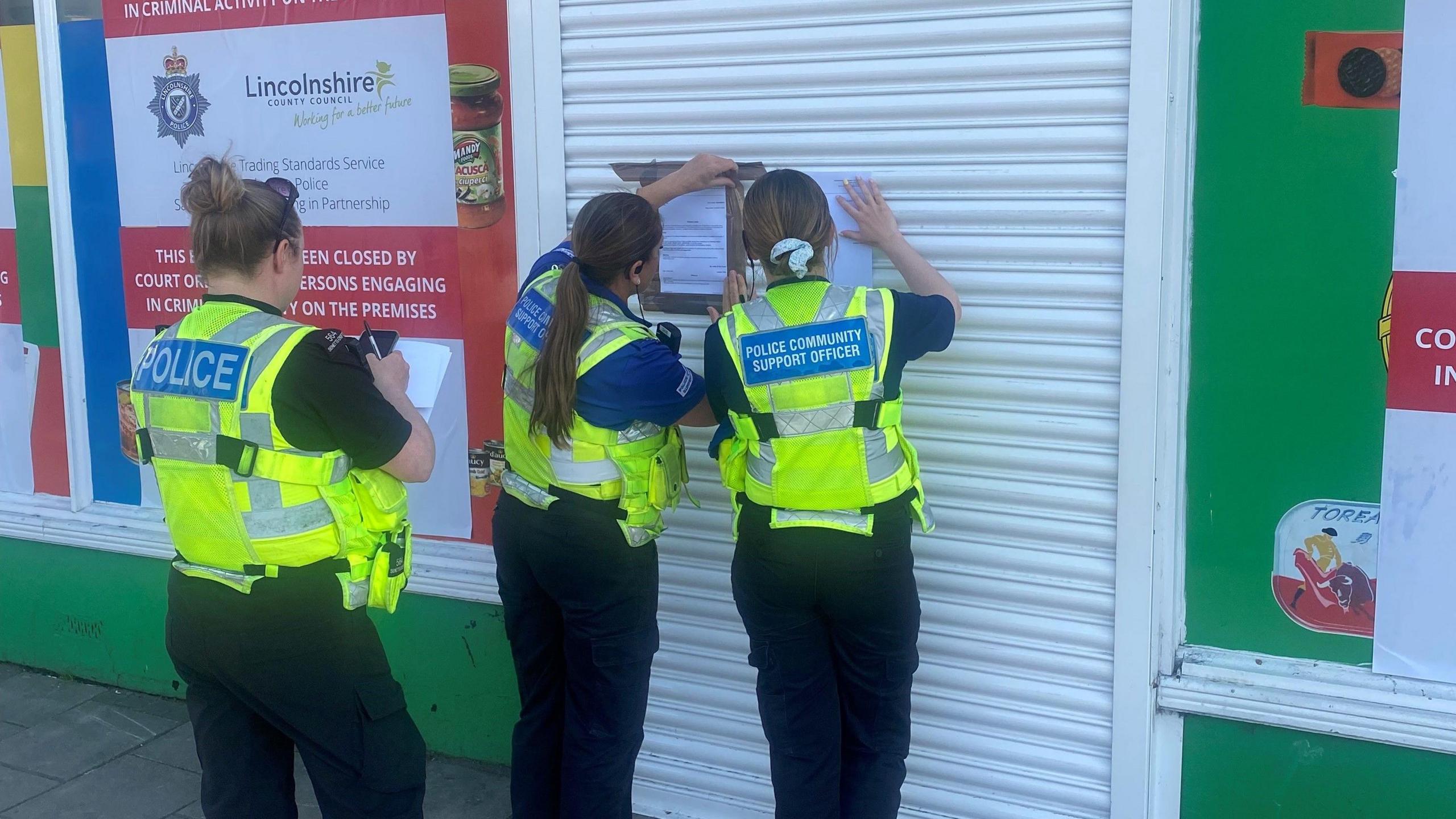 Lincolnshire Police post enforcement notices on the shutters of a shop in Grantham