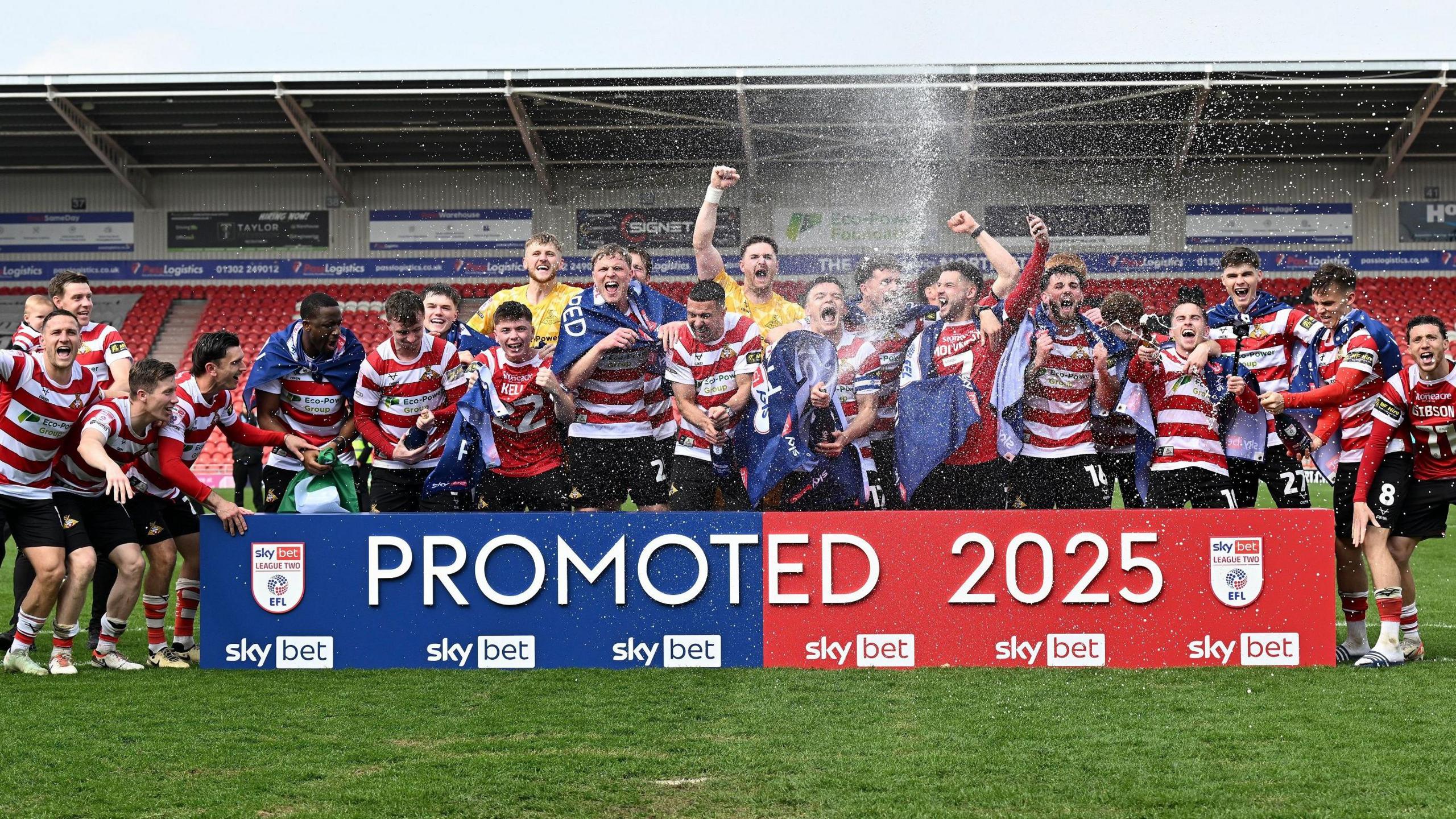 Doncaster celebrate promotion following victory over Bradford