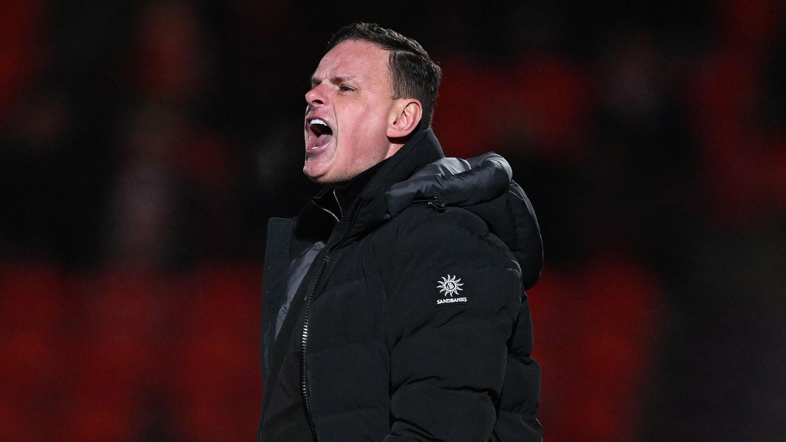Leyton Orient boss Richie Wellens shouting at his team from the touchline.