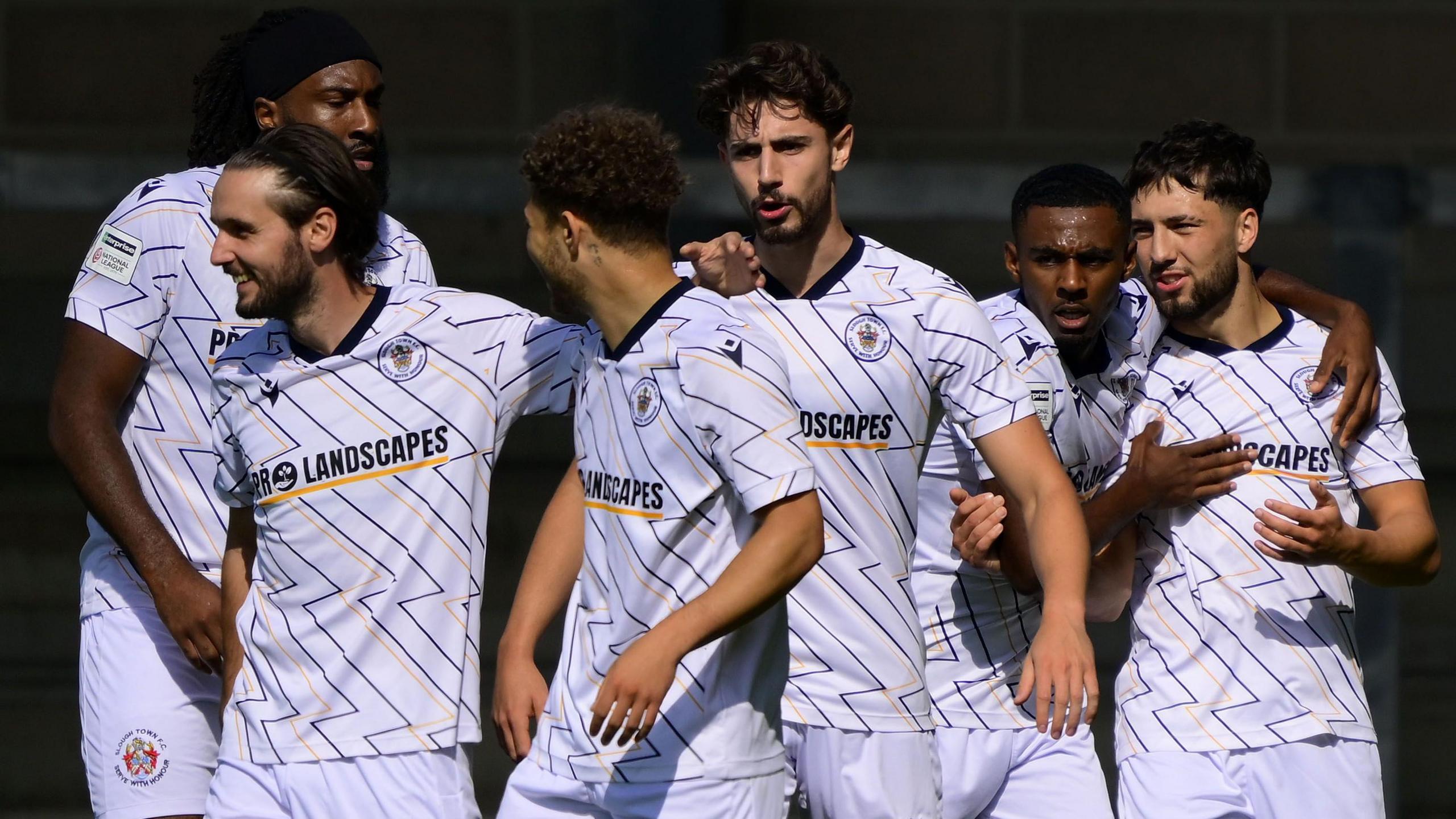 Slough Town players celebrate a goal in a game against Torquay