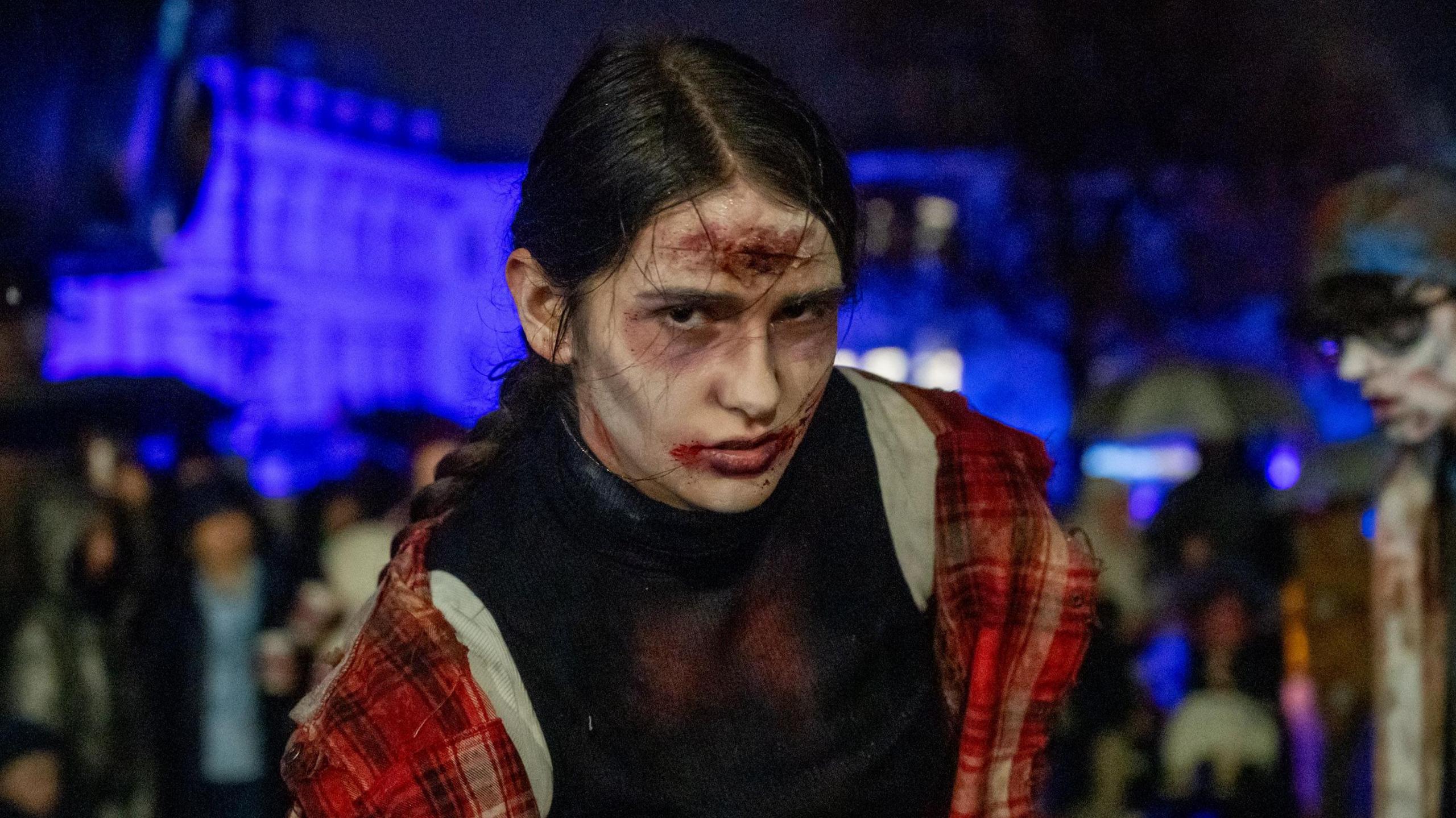 Young man in zombie dress taking part in Halloween parade in Derry