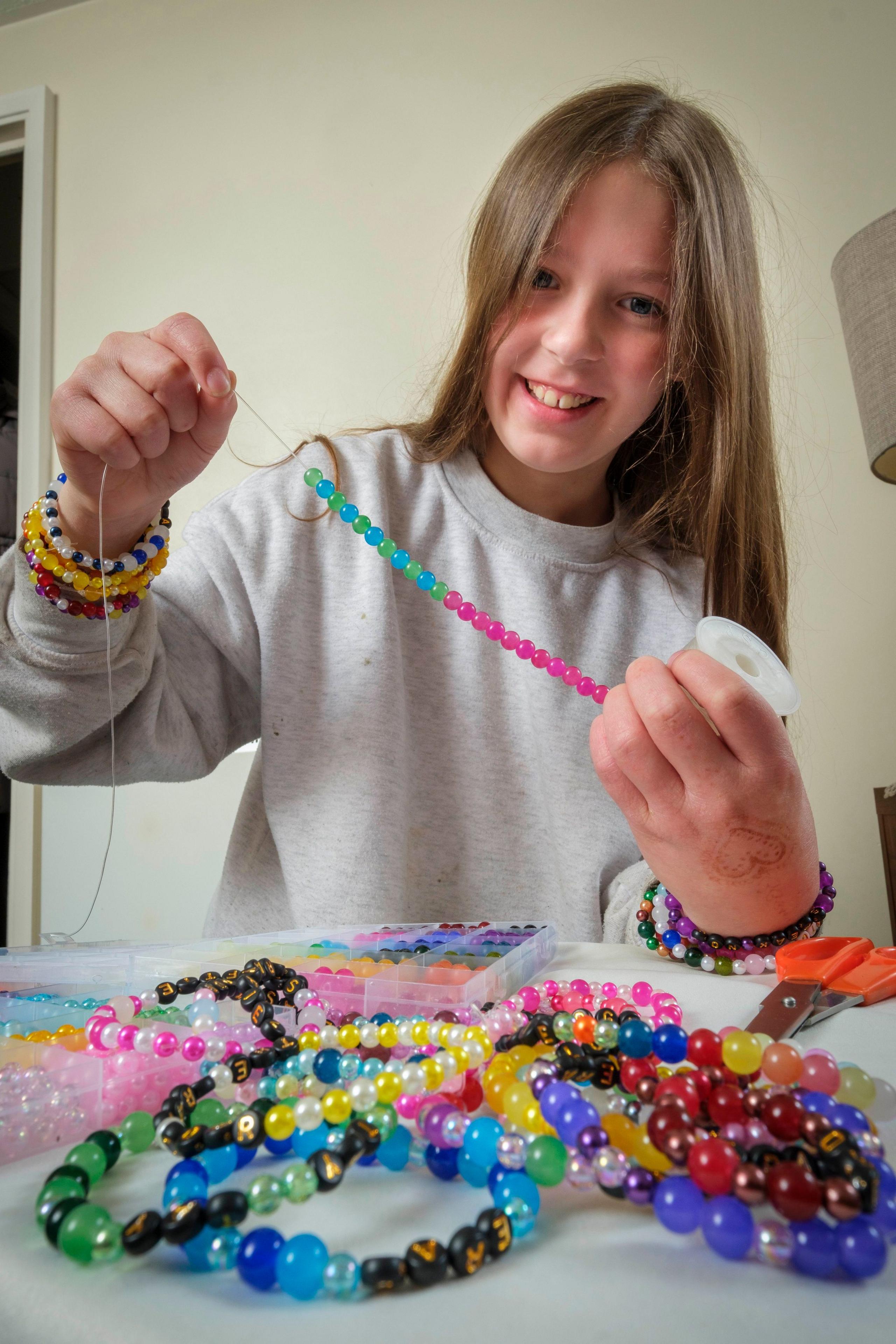 Girl holding up friendship bracelet