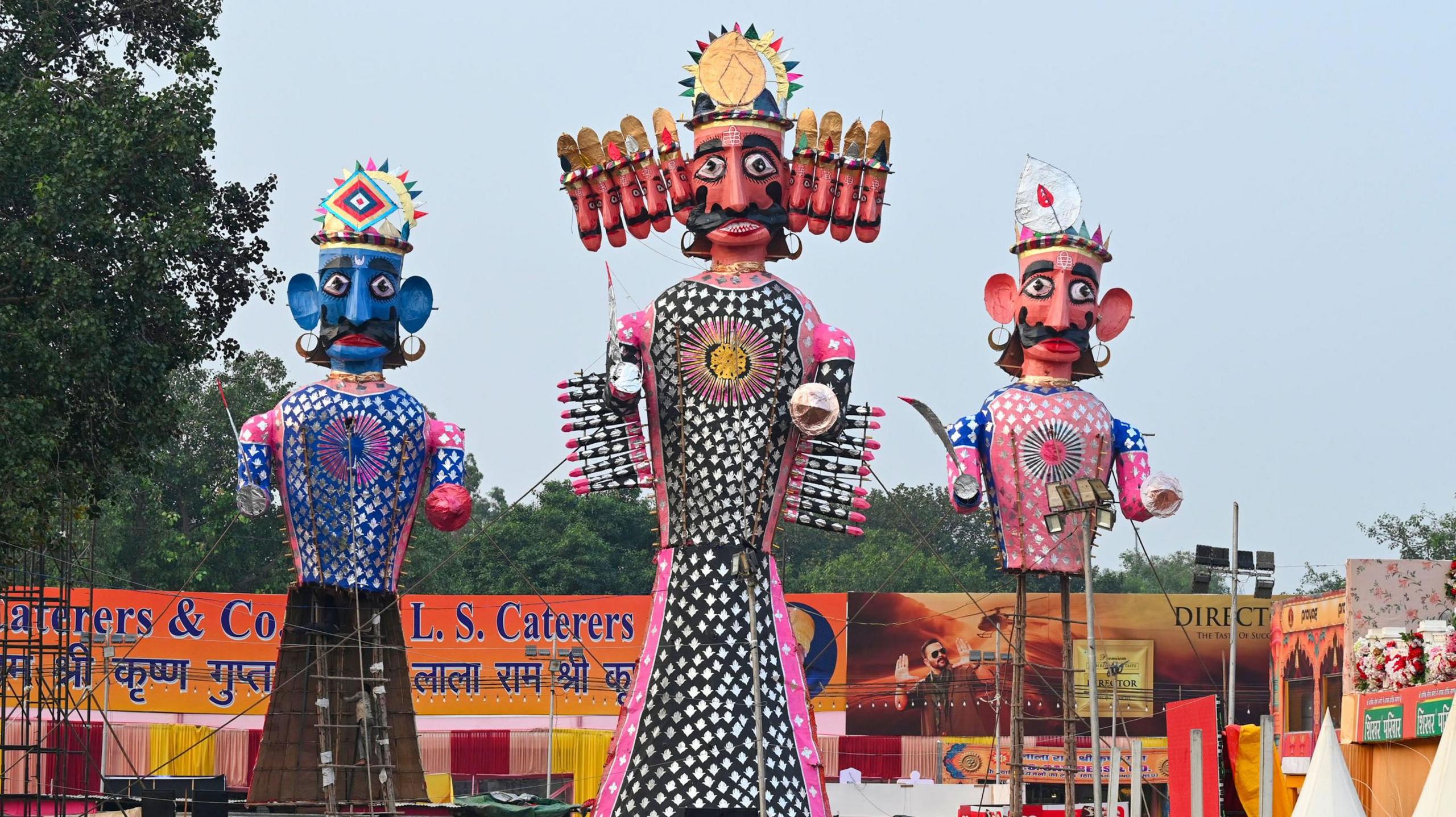 Colourful effigies of Ravana, Meghnath, and Kumbhkaran erected for burning, at Red Fort in Delhi. 