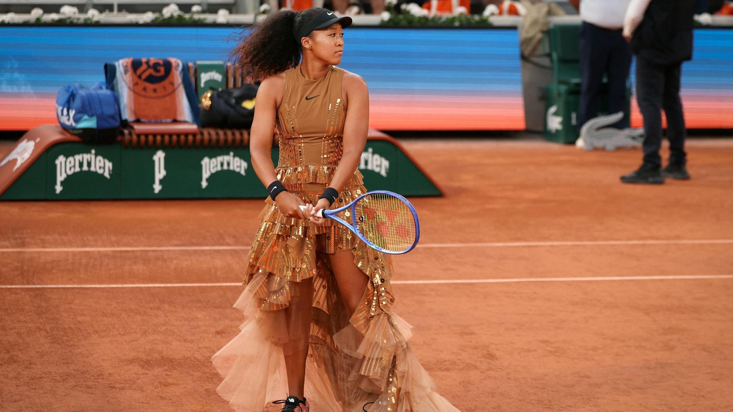 Naomi Osaka warms up in her dress
