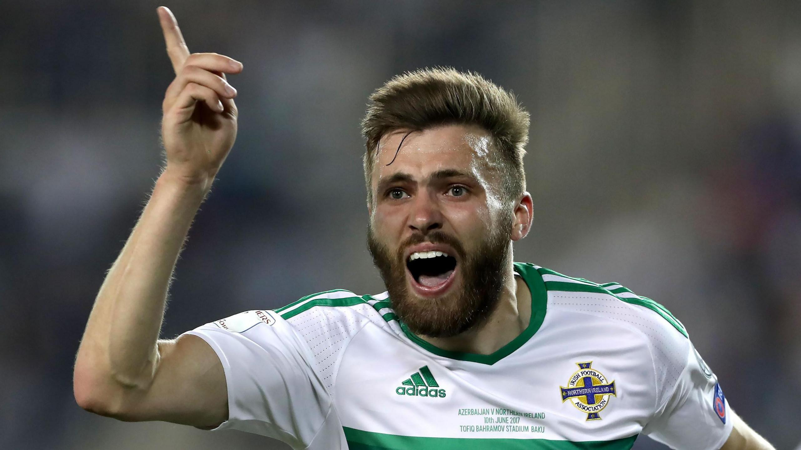 Stuart Dallas celebrates one of his three goals for Northern Ireland