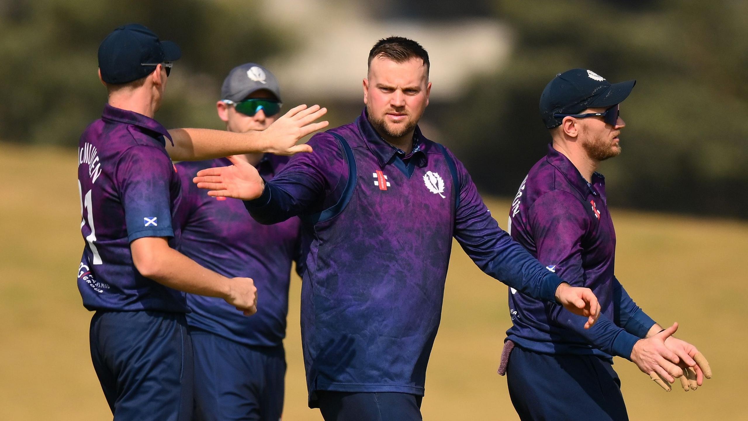 Mark Watt celebrates taking a wicket against Afghanistan in a T20 World Cup warm-up match