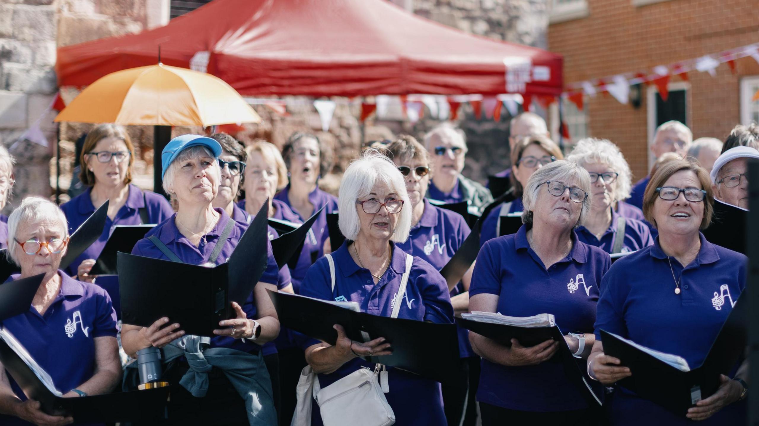 Female choir singers perform a song.