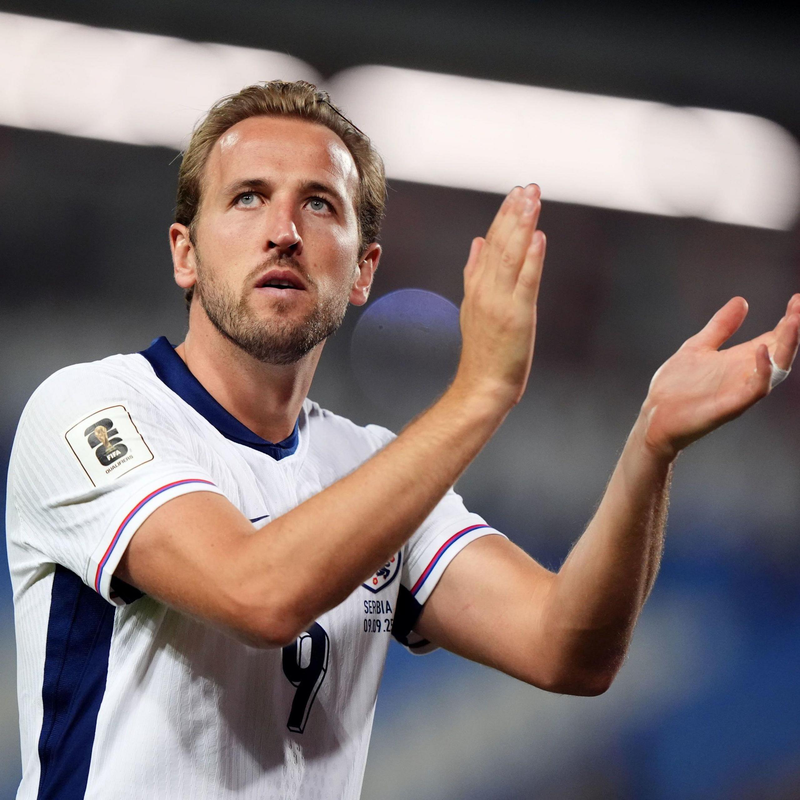 Harry Kane claps while playing for England