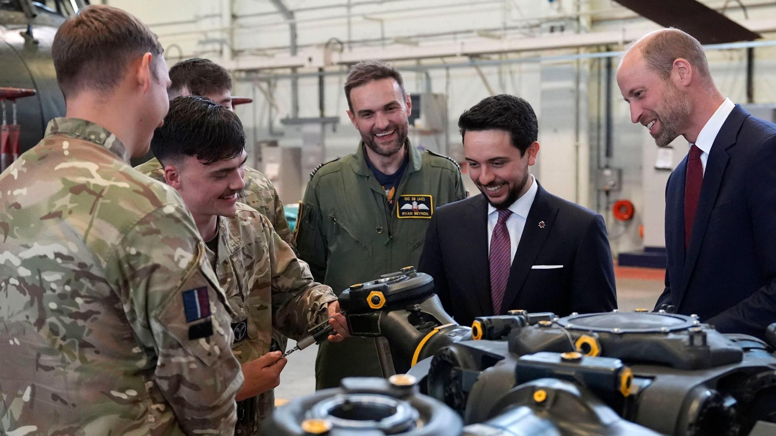 The Prince of Wales (right) and the Crown Prince Hussein of Jordan look at a main rotor head from a chinook helicopter as they meet trainee aircrew and staff from No. 28 (AC) Sqn and No. 22 Sqn during a visit to RAF Benson in Wallingford, Oxfordshire.