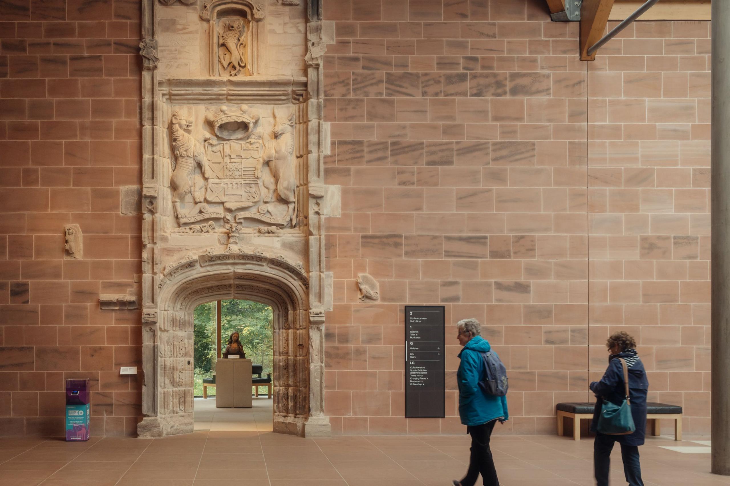 The Burrell's famous stone archway takes visitors from the entrance hall into the gallery. The archway has a carved coat of arms above and intricate stonework around the archway.