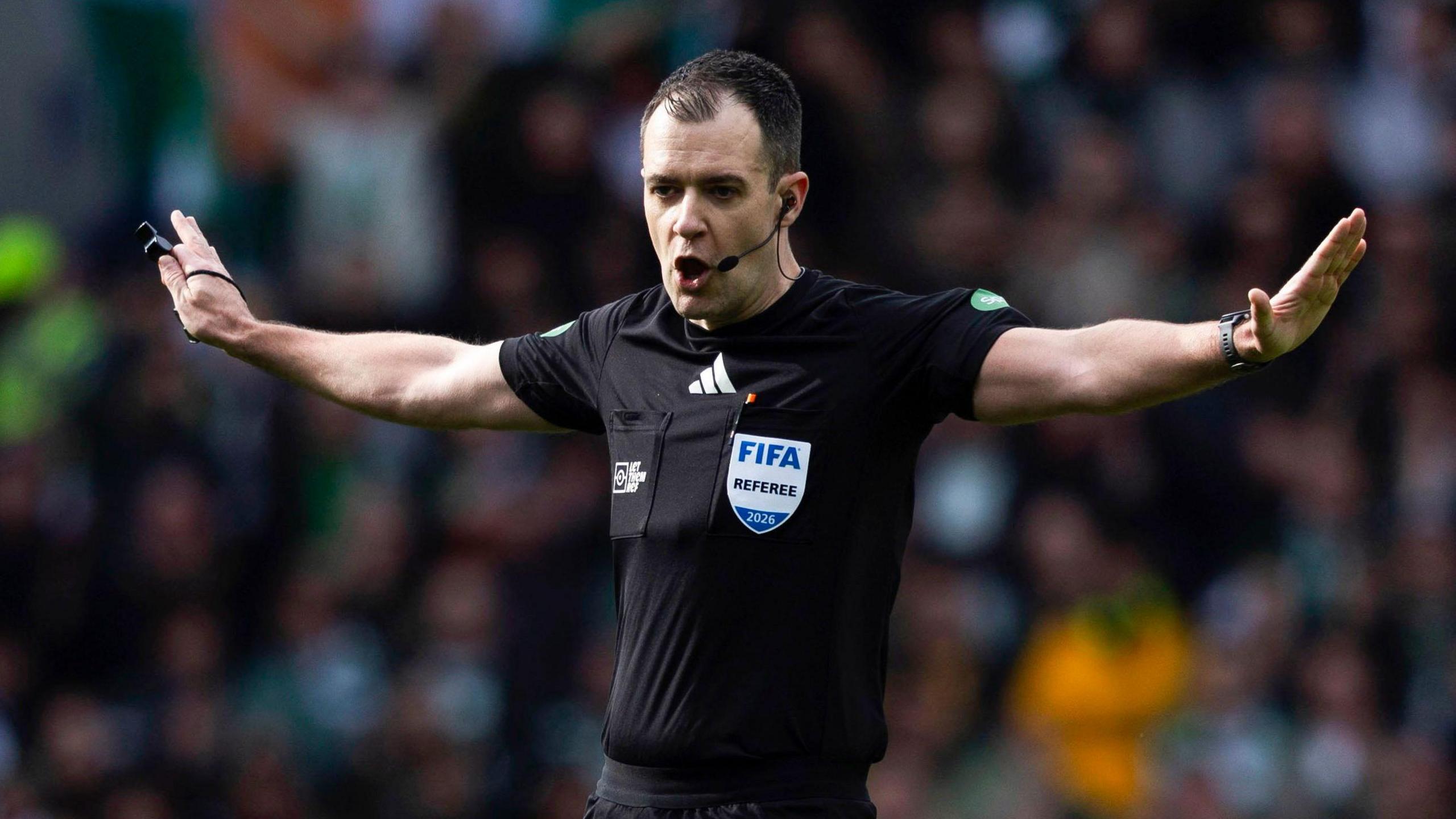 Referee Don Robertson waves away appeals