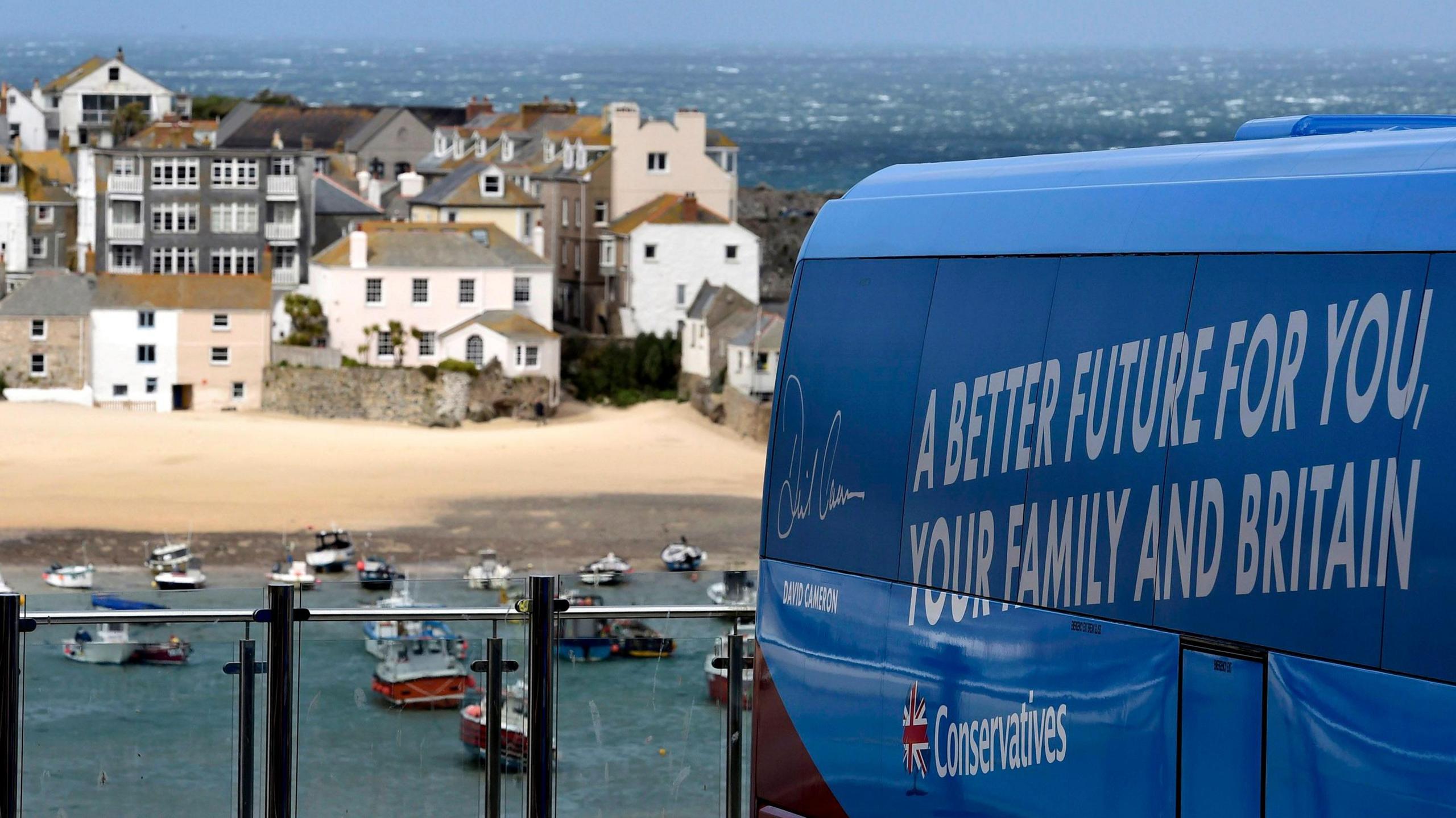 The Conservative election battle bus pictured in St Ives, Cornwall in 2015. It is blue and has the words "a better future for you, your family and Britain" written on it.