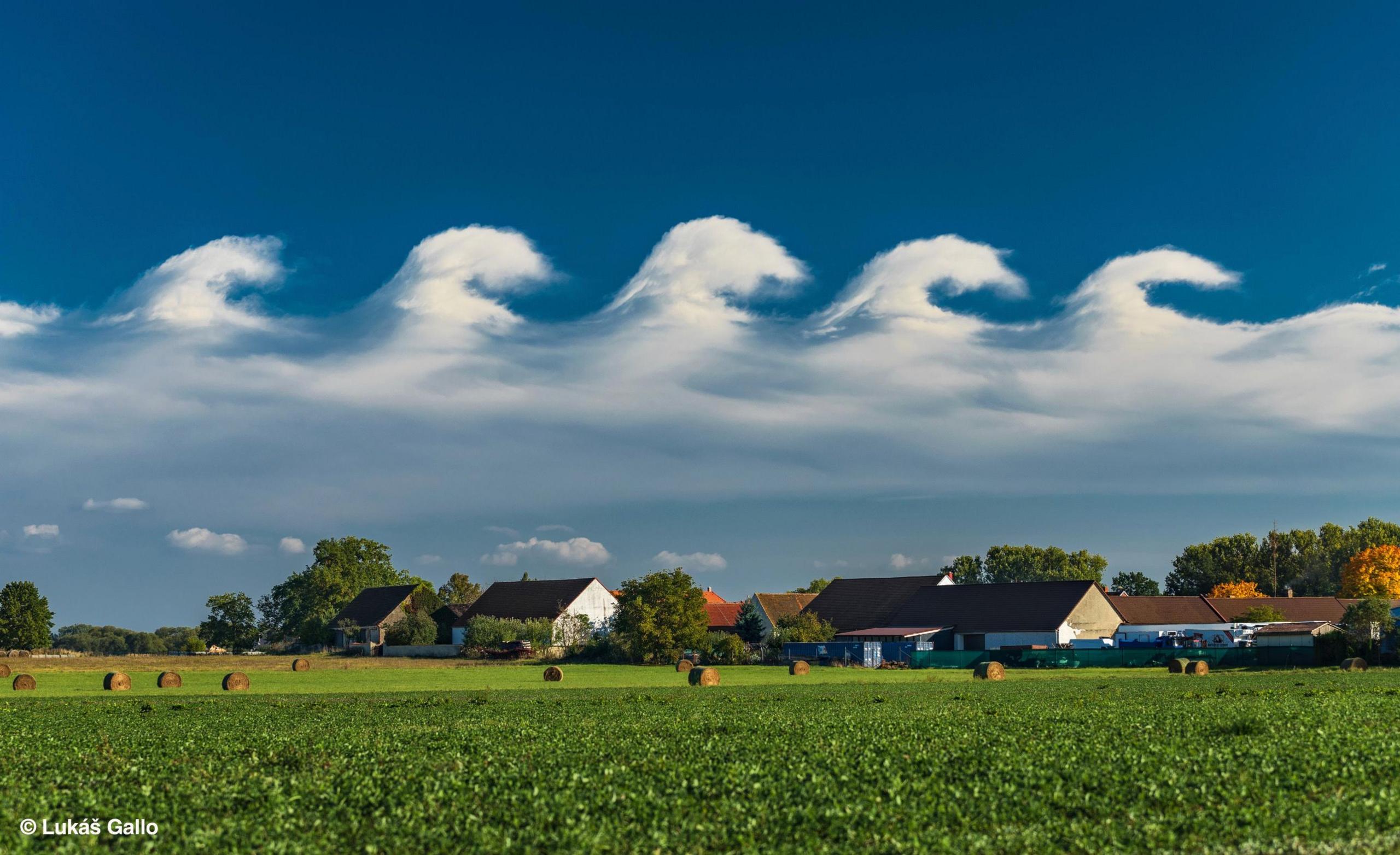Clouds in a wave formation above a field 