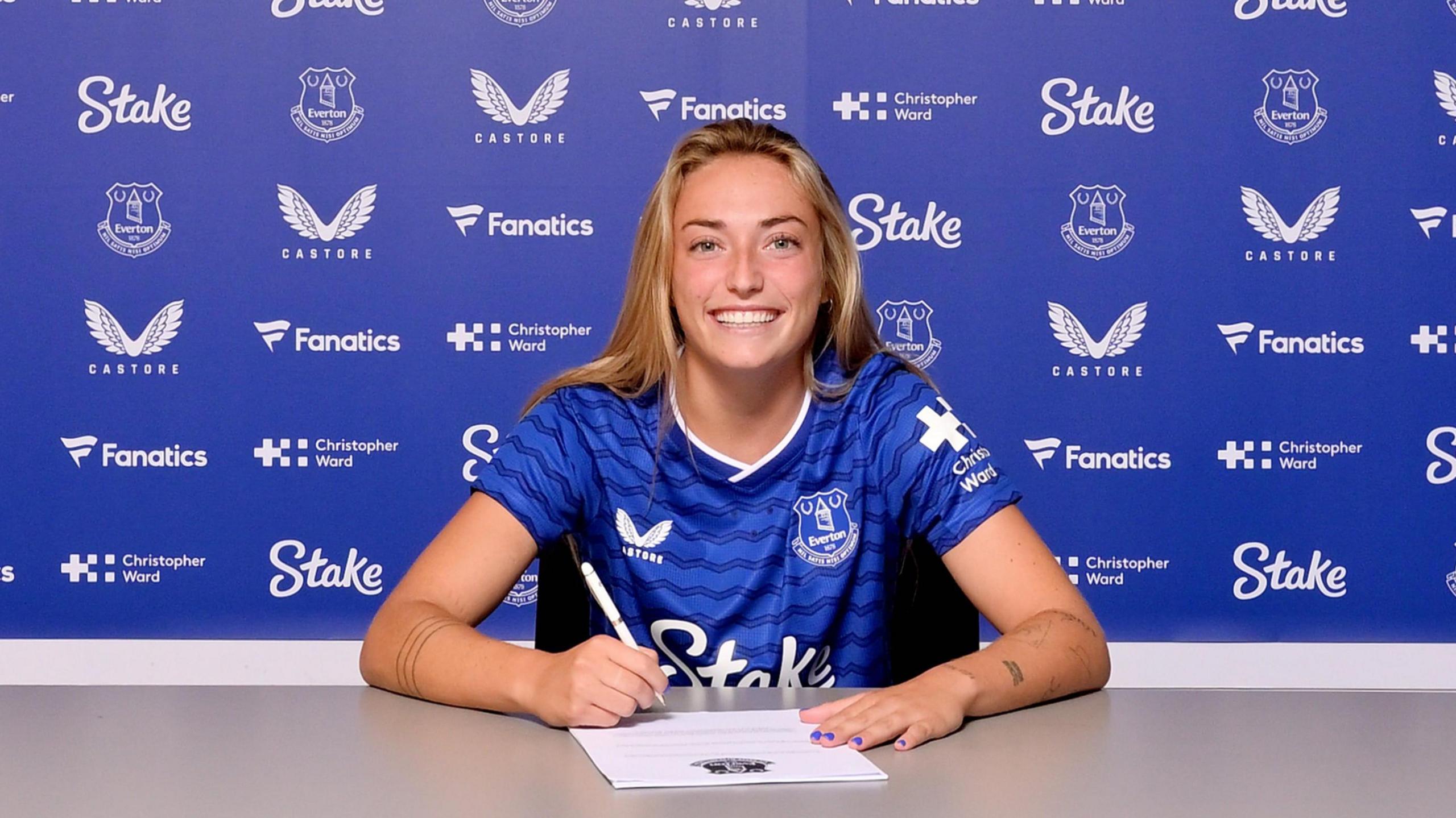 Ornella Vignola posing in an Everton top while signing her contract