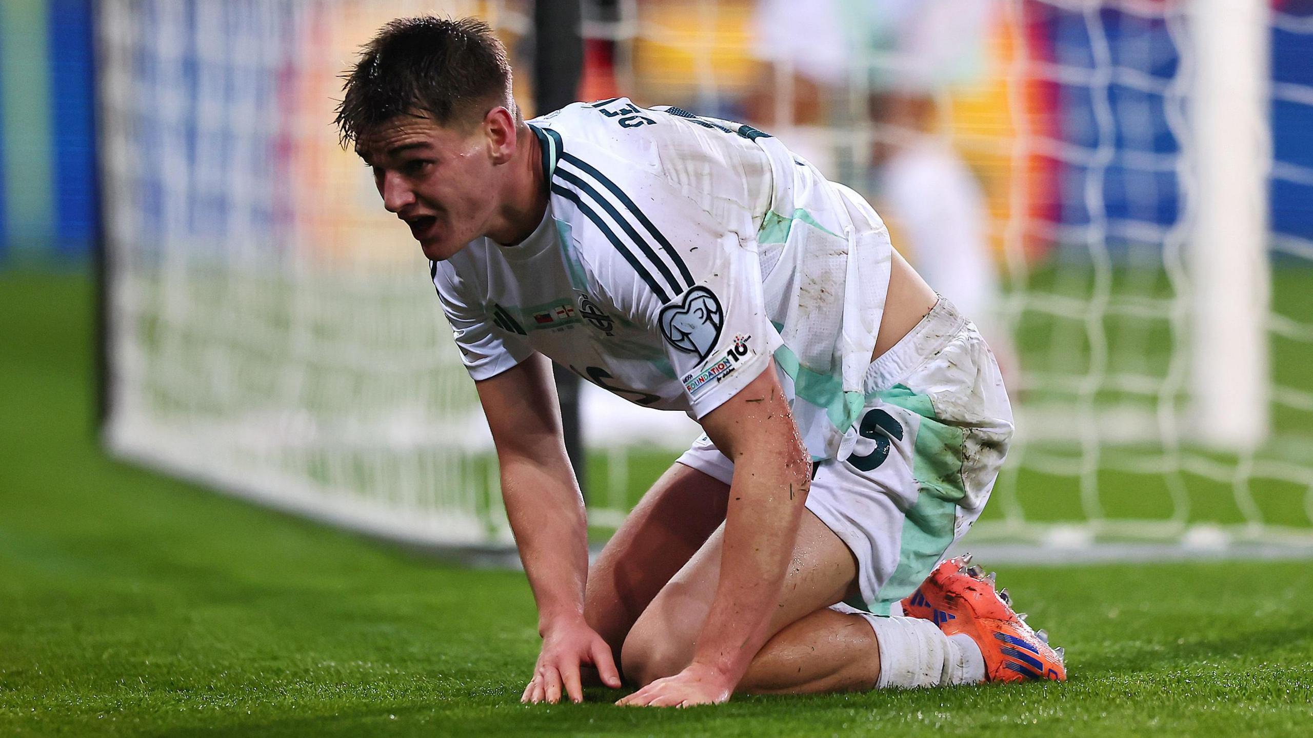 Northern Ireland's Justin Devenny crouches by the goal