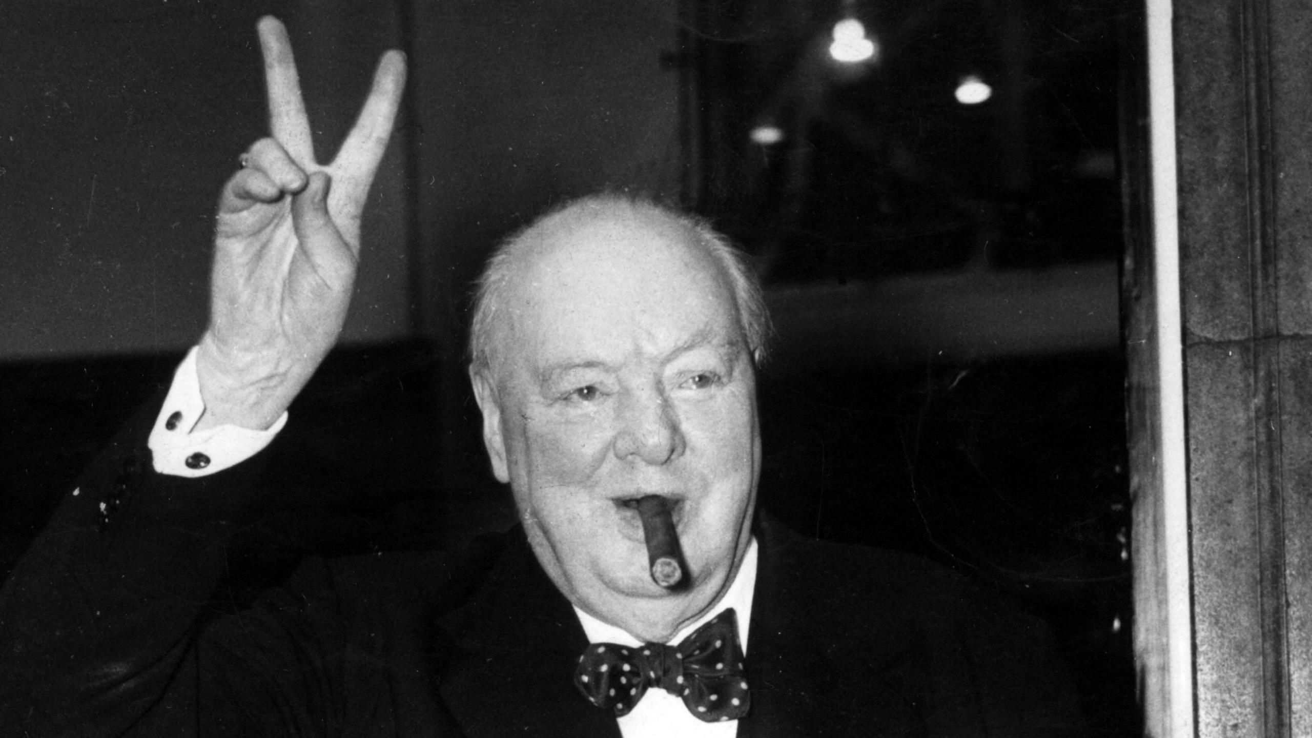 Winston Churchill gives his familiar and famous "V for Victory" sign after a lunchtime meeting at 10 Downing Street with then American Secretary of State John Foster Dulles on 17 September1954.