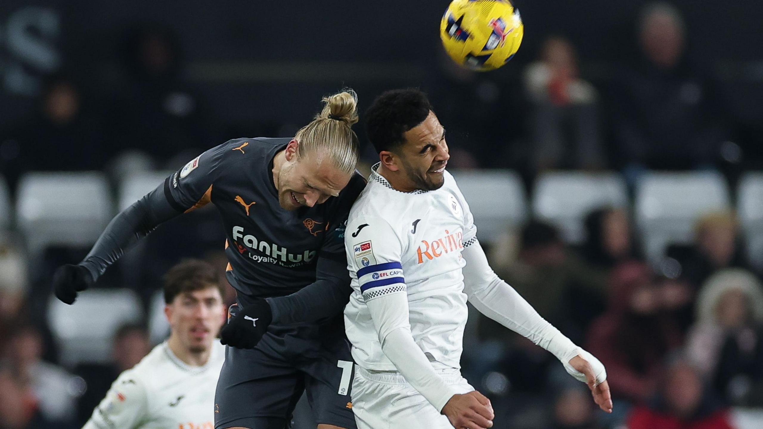 Ben Cabango of Swansea City wins the ball from Lars-Jorgen Salvesen of Derby County