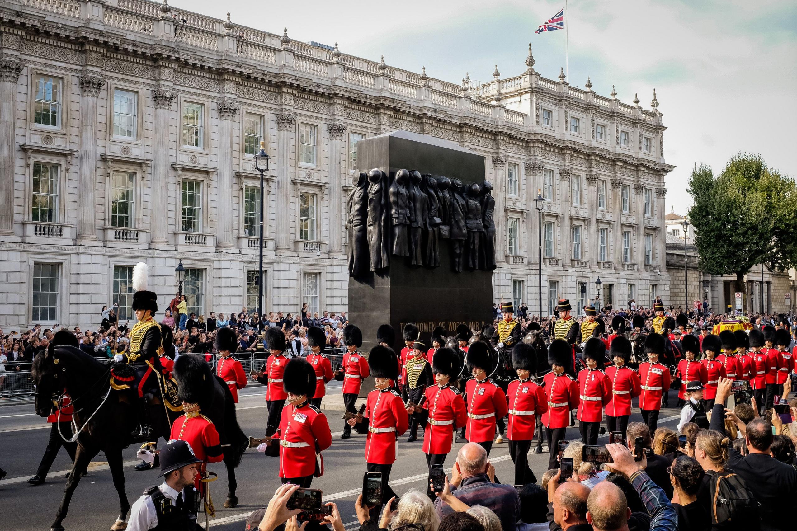 A military horse called Yogi leads the procession through London (past the Cenotaph) in Westminster, at the funeral of Queen Elizabeth II in 2022. Members of the armed forces are seen in traditional dress uniforms. 