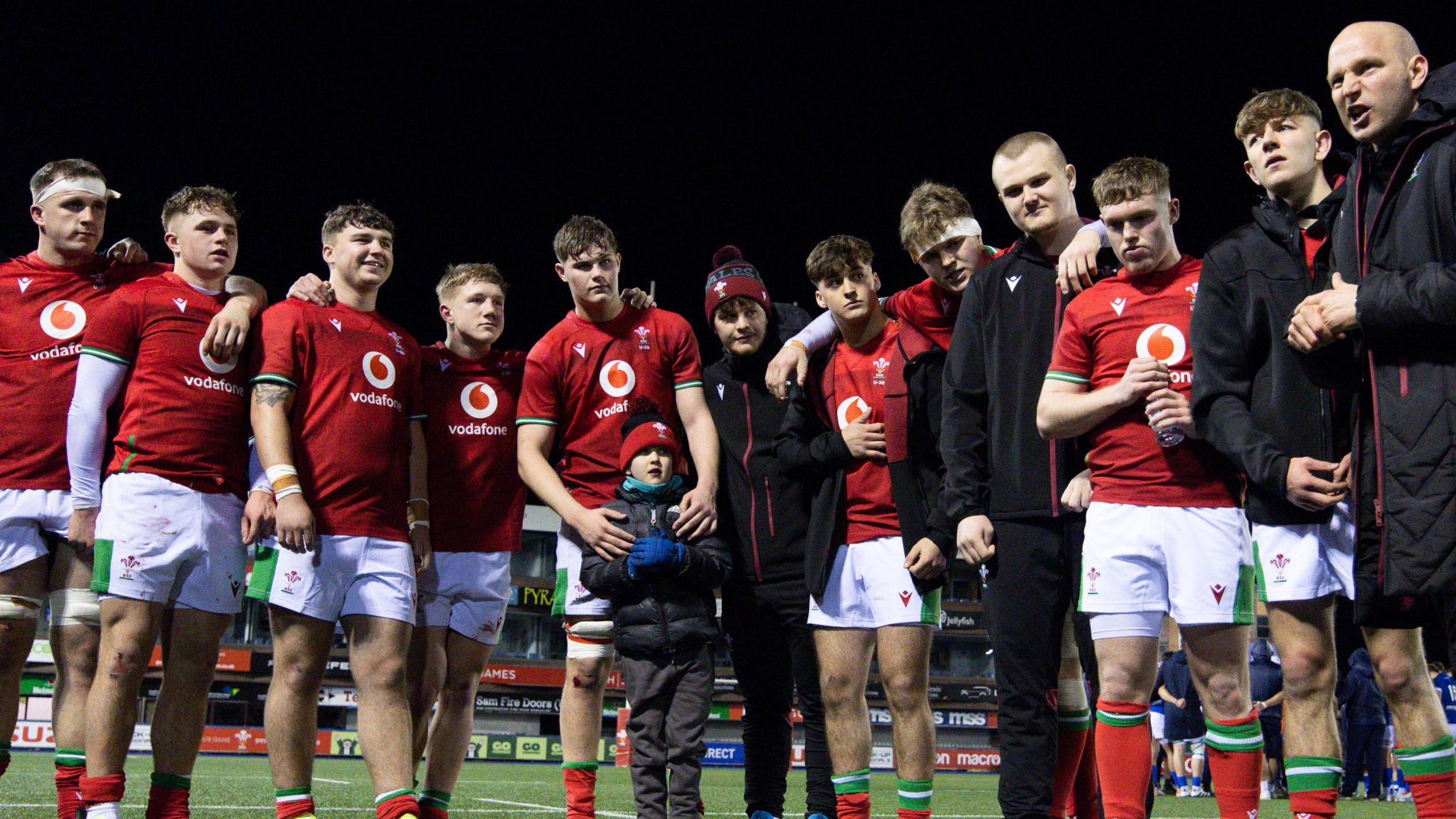 Members of the Wales' 2024 under-20s Six Nations squad with coach Richard Whiffin (R)