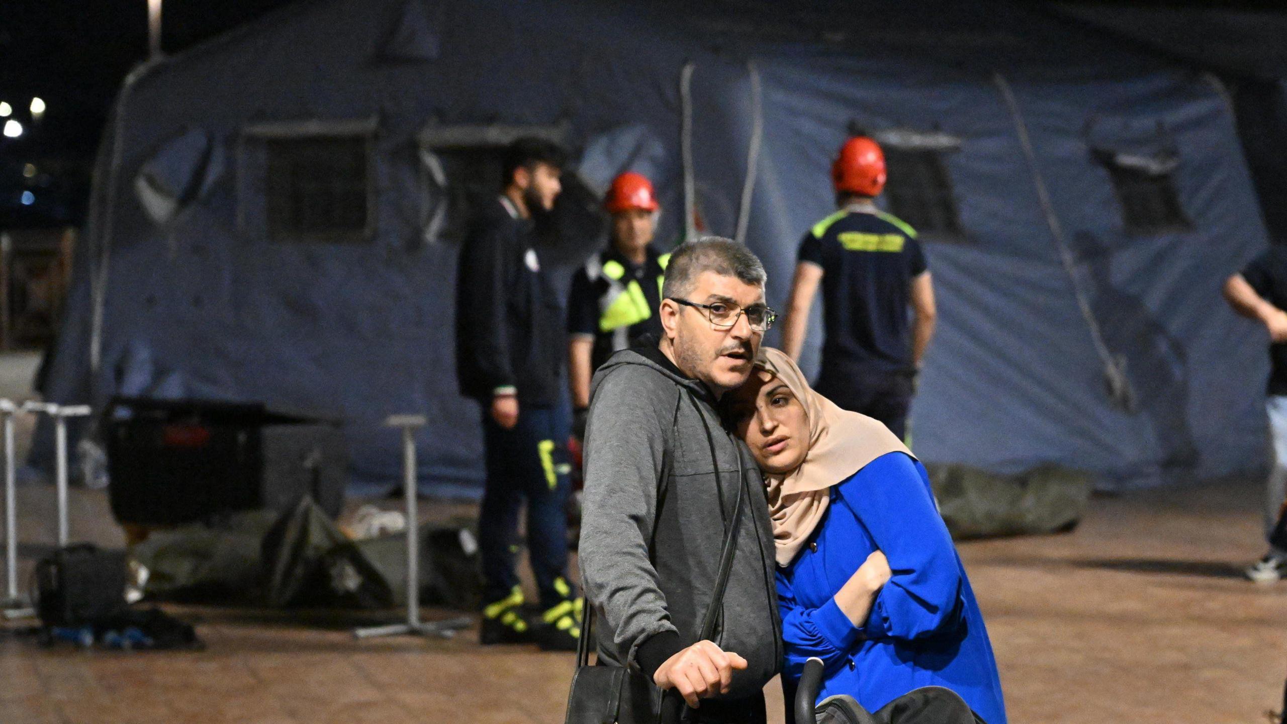 Two residents of Pozzuoli outside a tent camp