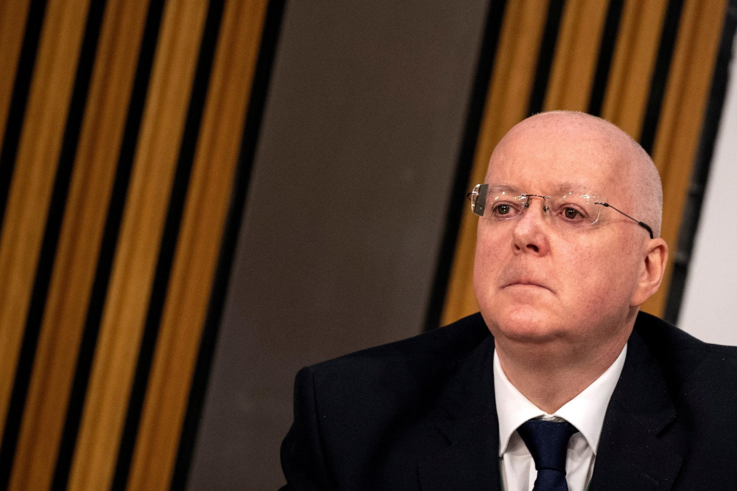 Peter Murrell sitting in parliament while being questioned by MSPs