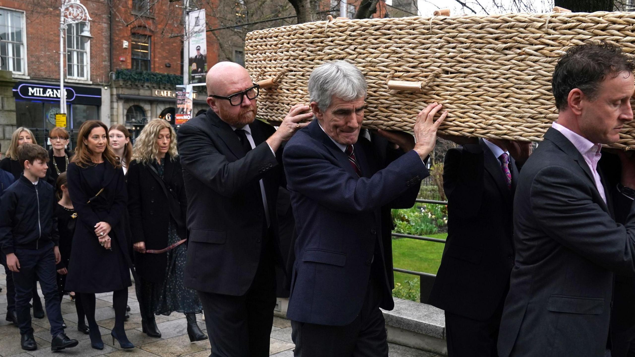 The family of Charlie Bird walking behind the coffin