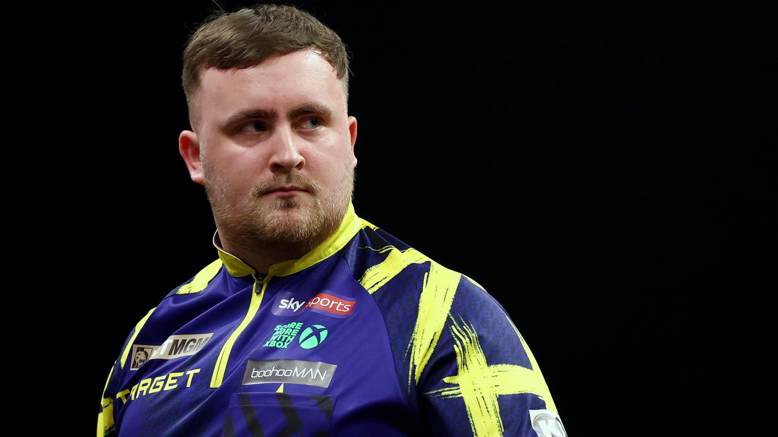 Luke Littler with a perturbed looks on his face