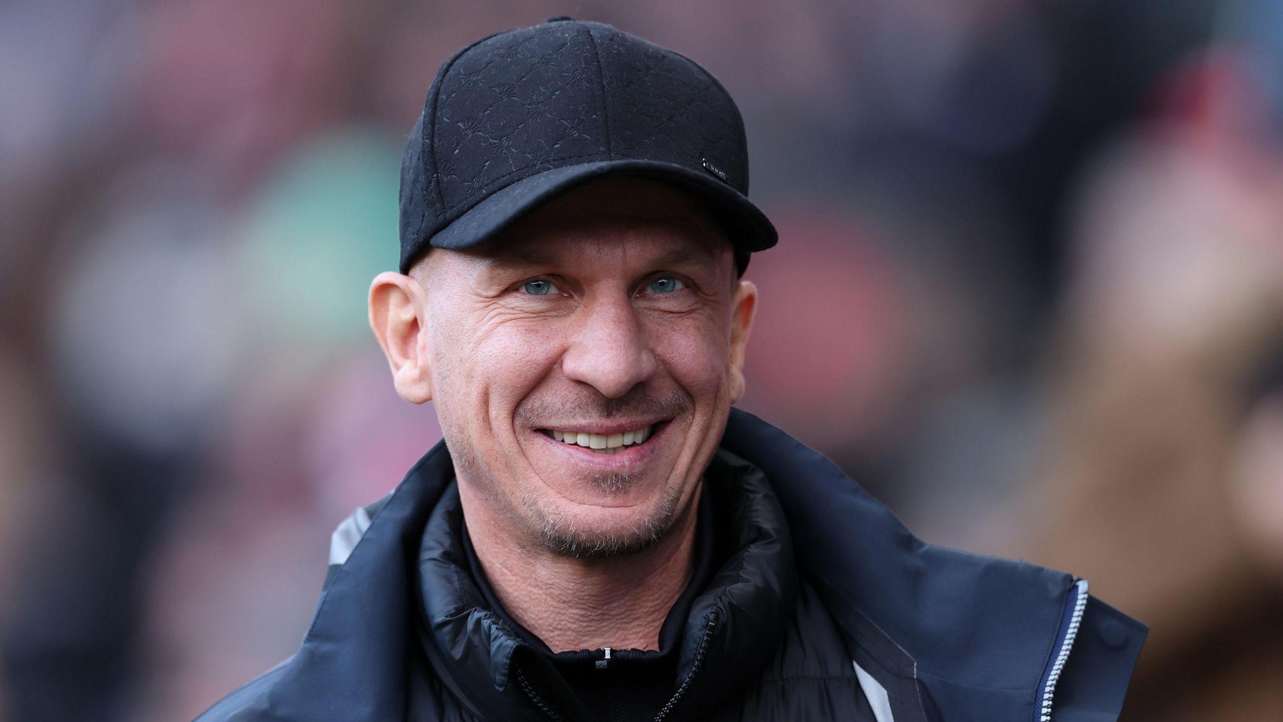 A close up of Bristol City boss Gerhard Struber wearing a black cap
