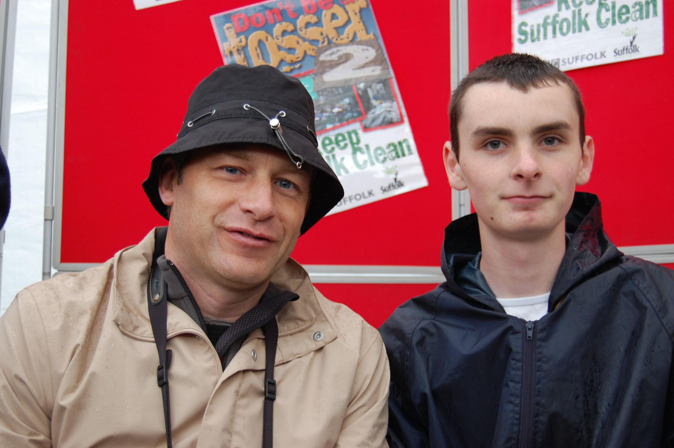 Chris Packham in a bucket hat with another man to his left