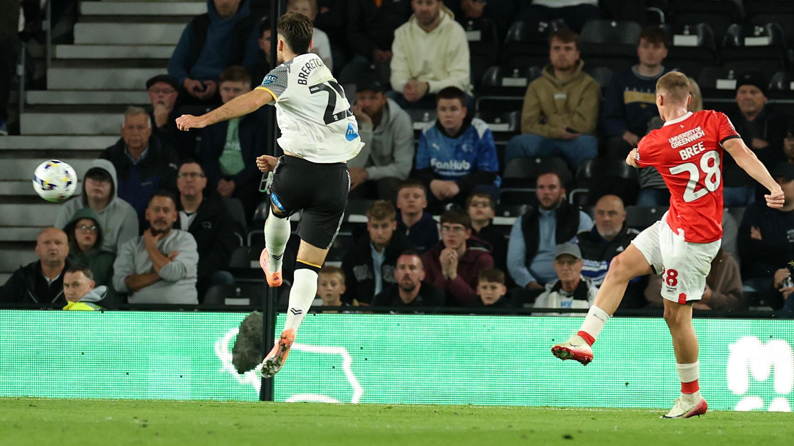 James Bree volleys at goal for Charlton, with Ben Brereton Diaz attempting to block for Derby