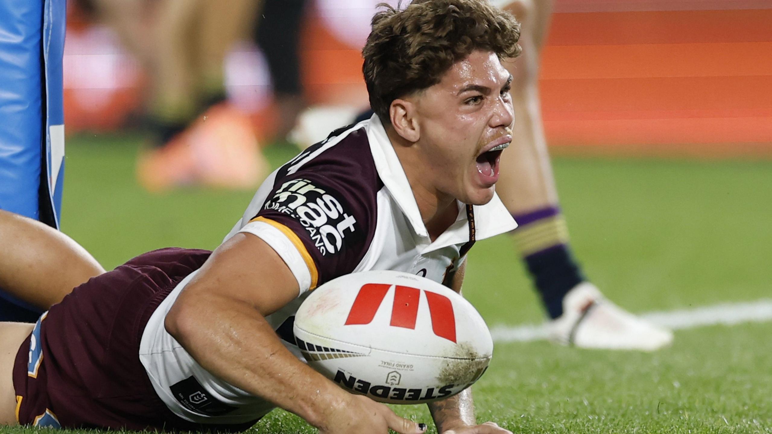 Reece Walsh celebrates scoring a try