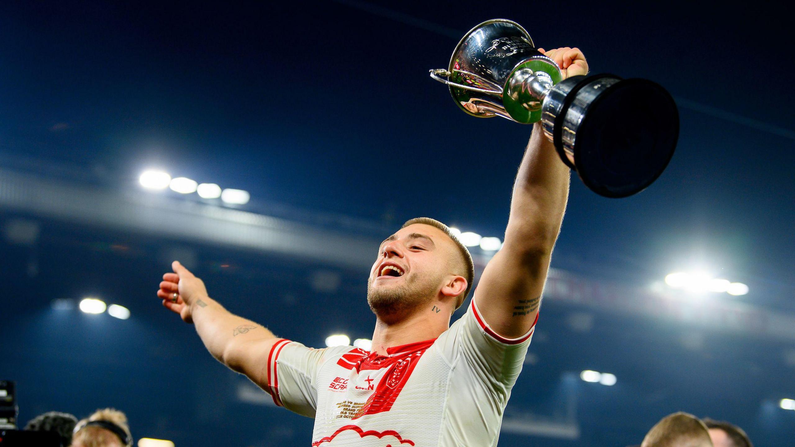 Hull KR's Mikey Lewis holds the Rob Burrow Trophy after the Super League Grand Final