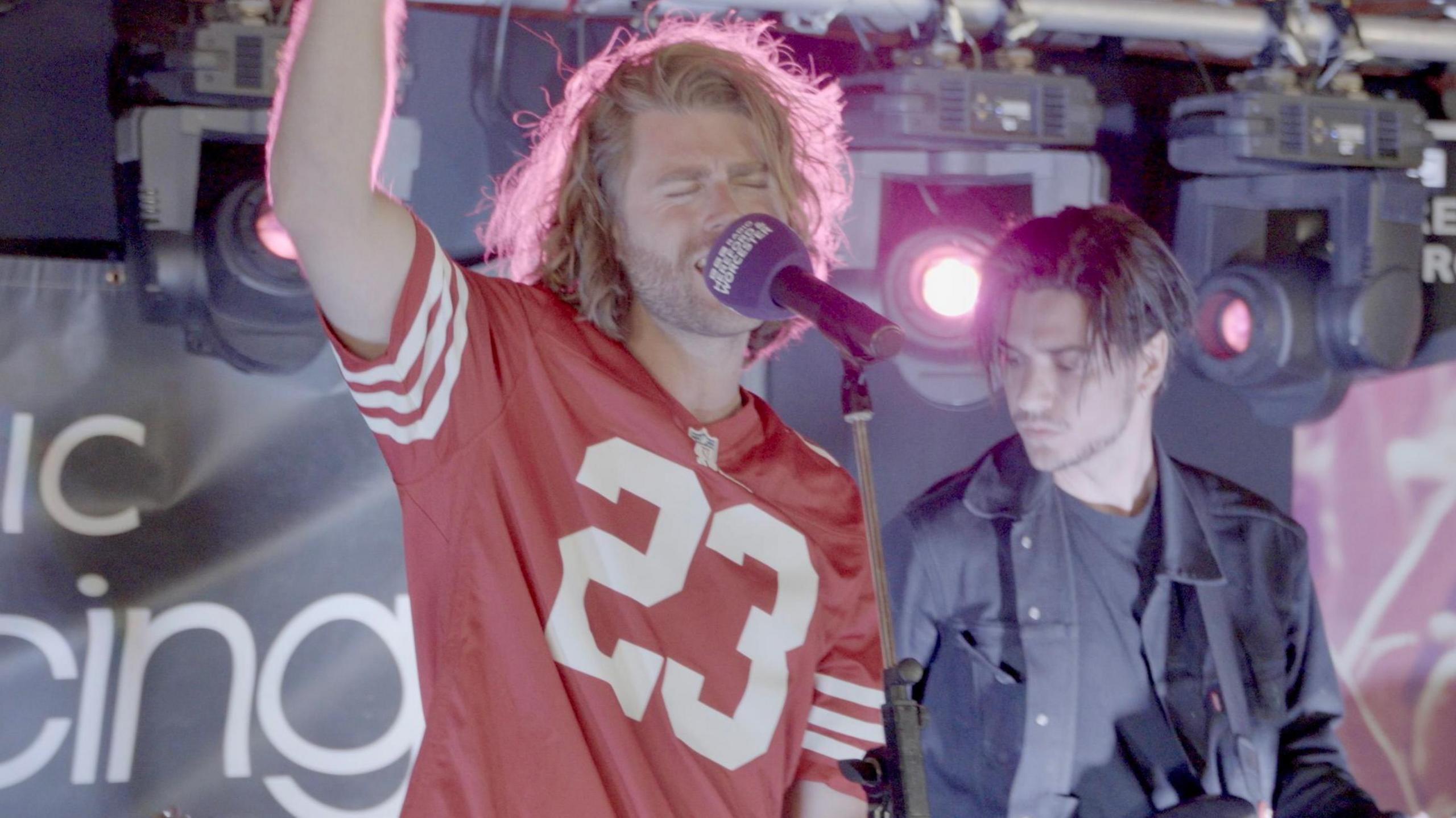 Conor Rabone singing in a 49ers jersey