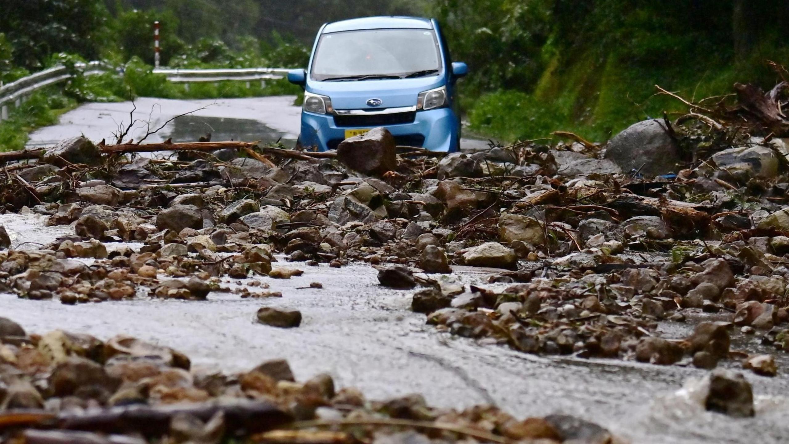 A road is covered with stones due to landslides caused by a torrential rain, in Wajima, Ishikawa Prefecture, Japan, 21 September 2024