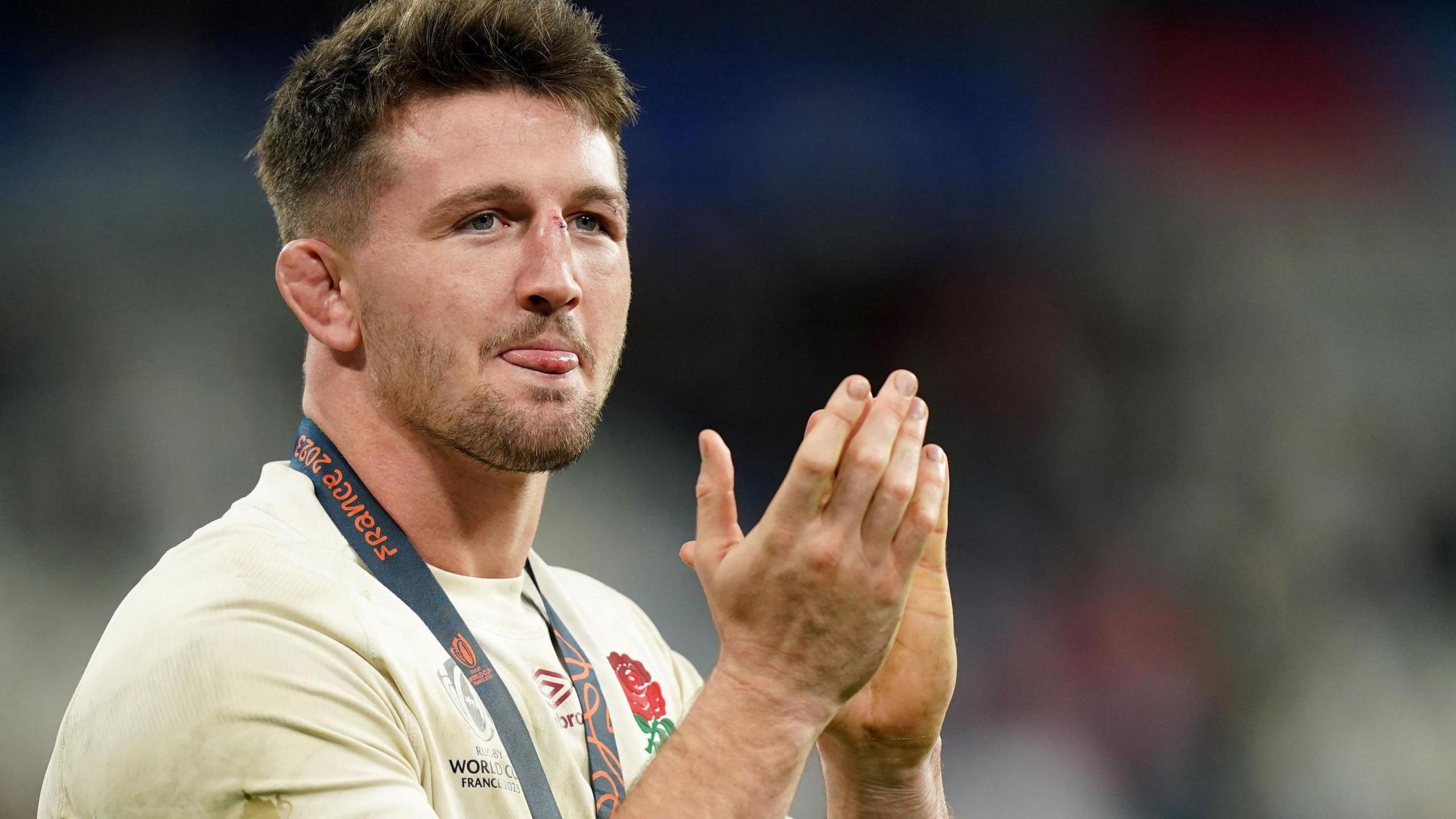 Tom Curry applauds while in action for England