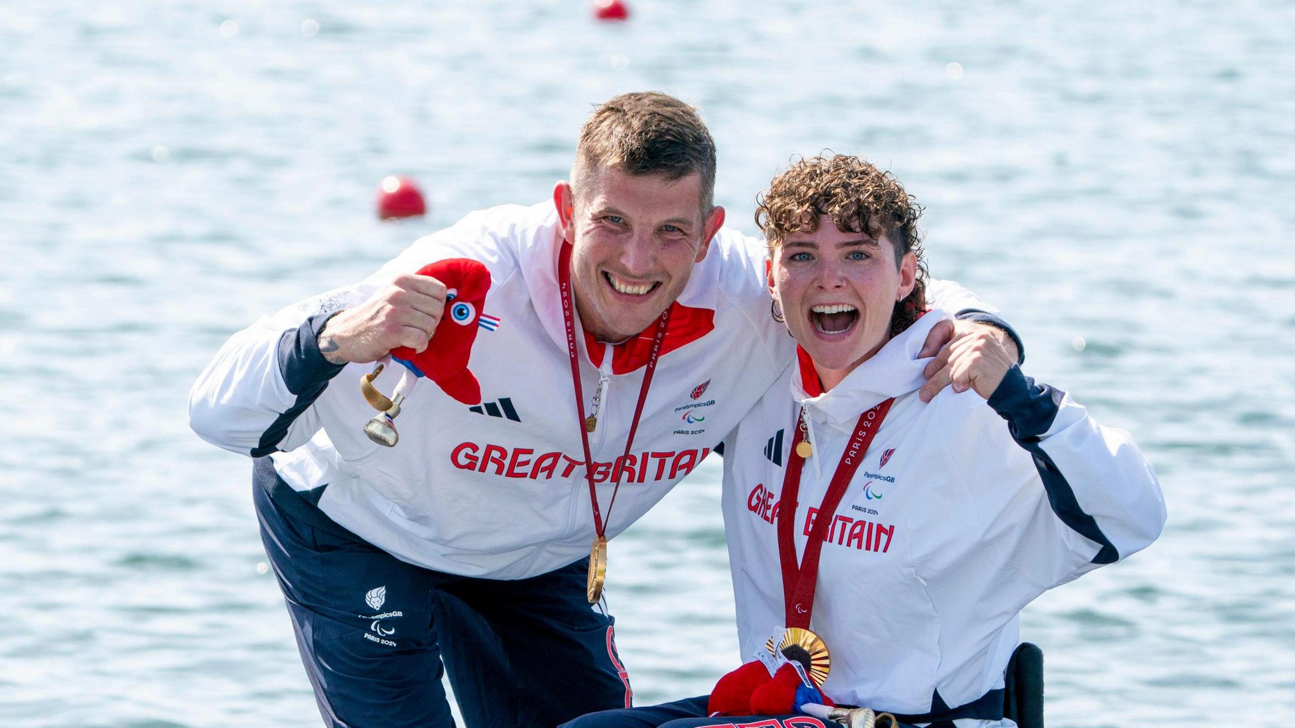 Team GB's Lauren Rowles and Gregg Stevenson celebrate with their gold medals.